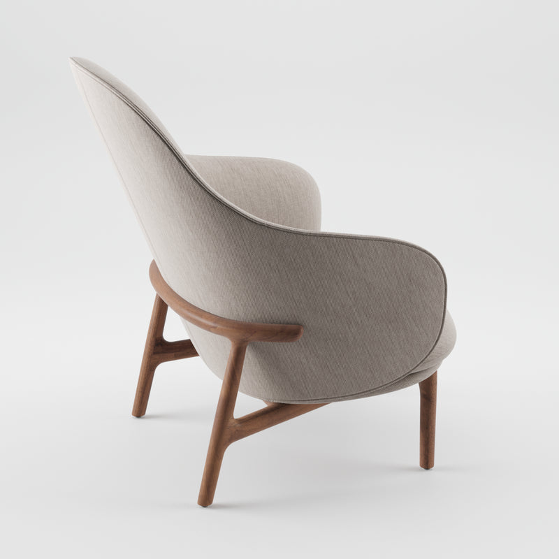 Side view of the MELA Lounge Chair High by Artisan, a mid-century inspired armchair featuring light gray upholstery and a smooth wooden frame, showcasing sleek minimalist design with elegant curves and comfortable seating.