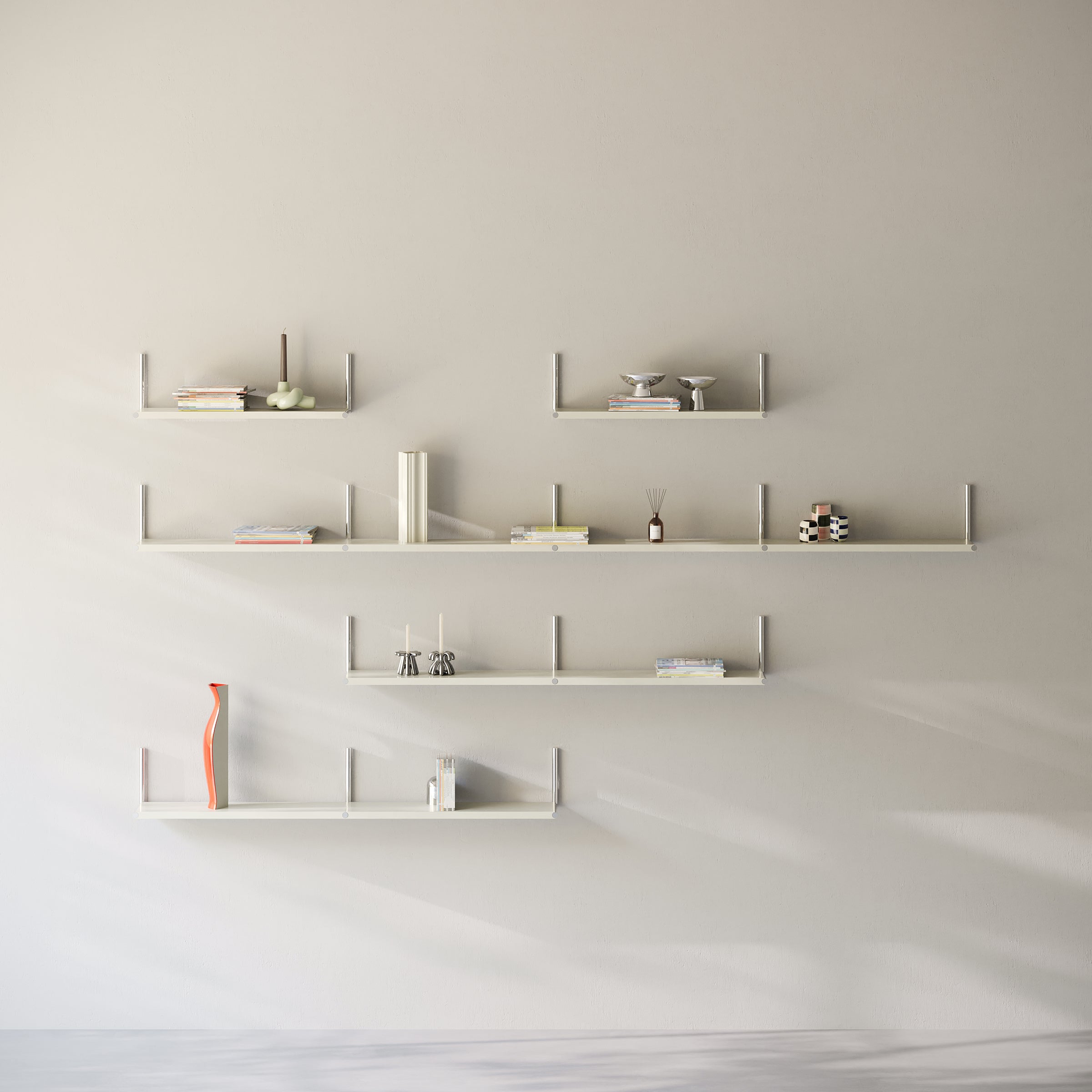 Minimalist white ELLE Shelf mounted on a wall with books and decorative items arranged neatly.
