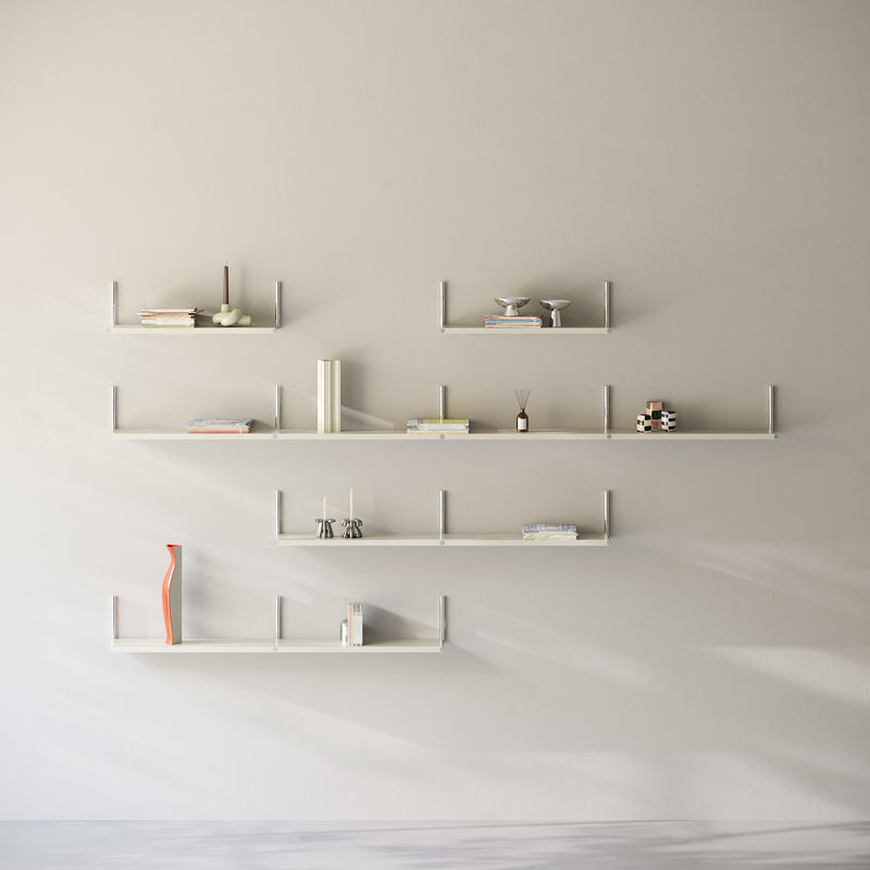 Minimalist white ELLE Shelf mounted on a wall with books and decorative items arranged neatly.