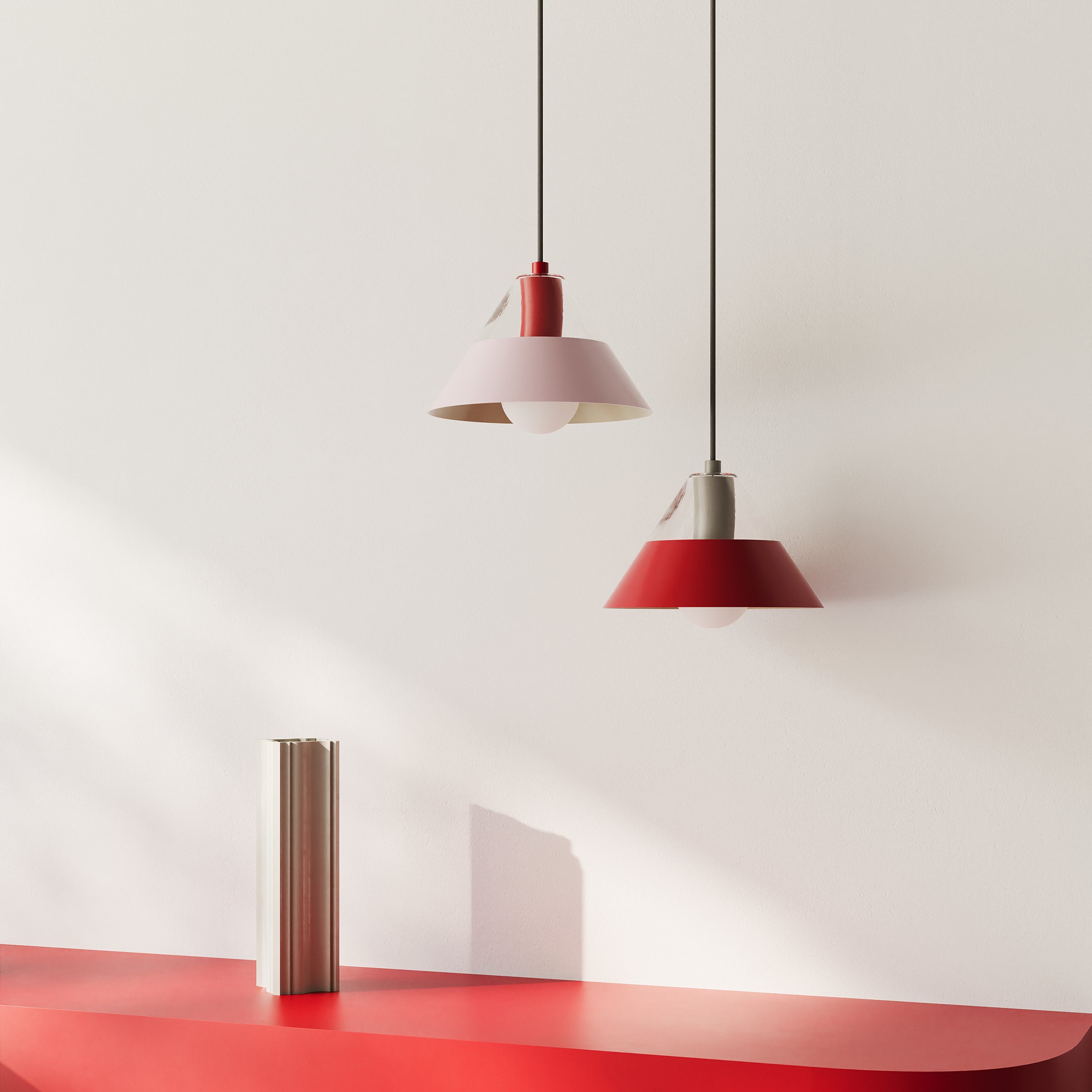FIFTY FIFTY lamp featuring dual glass and metal shades, creating balanced ambient and focused lighting in red and pink tones.