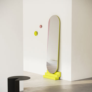 NONCHALANT Mirror with yellow lacquered solid beech stairs leaning against a white wall in a modern room setting.