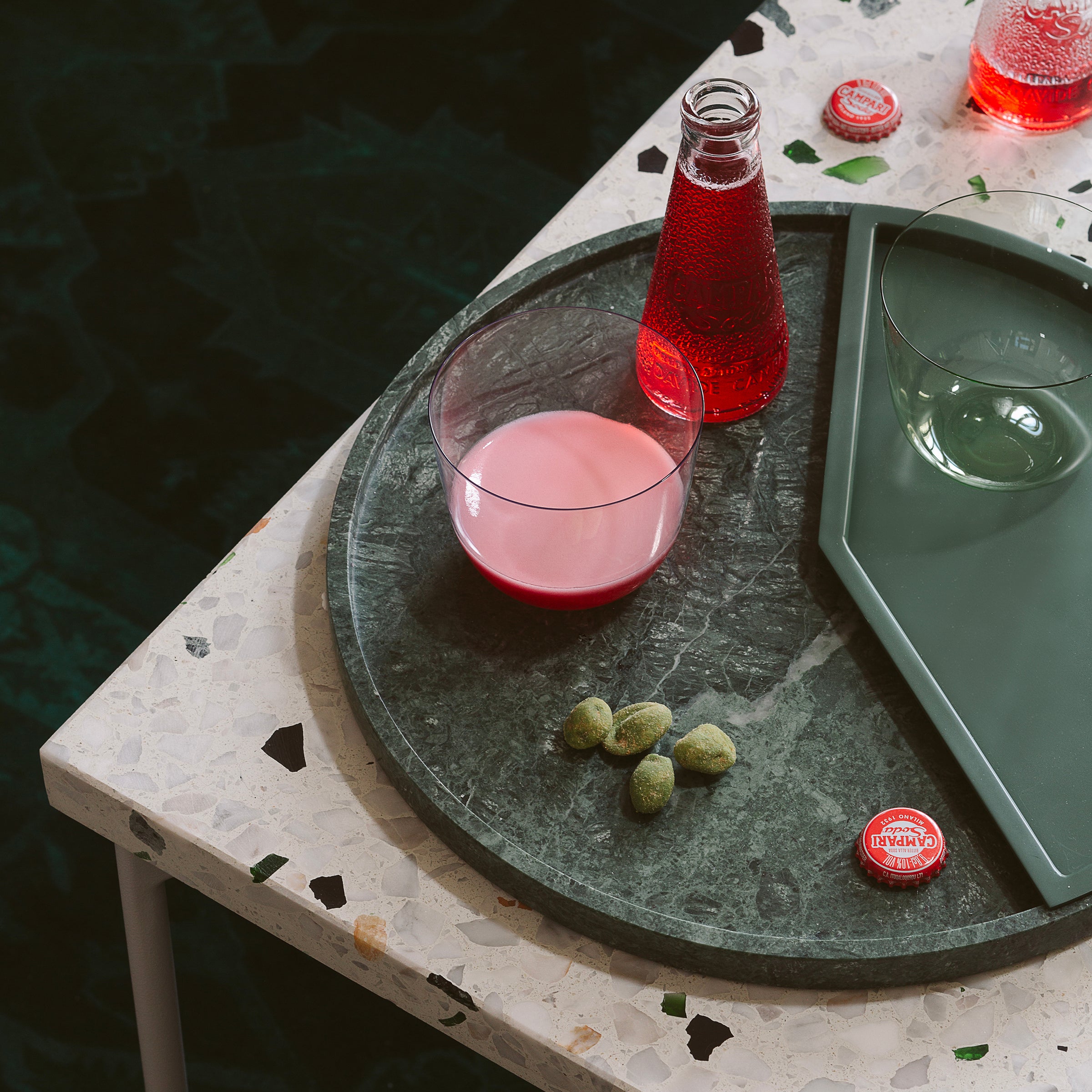 5 O' CLOCK Tray with round marble base and aluminum inlay, holding a glass, red drink, and snacks on table.