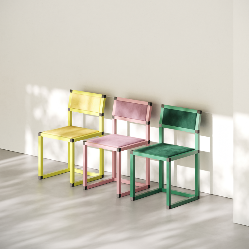 XD Chair set in yellow, pink, and green with aluminum frame and velvet upholstery in minimalist room.
