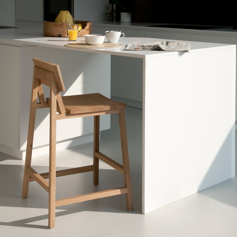 N3 Counter Stool by Ethnicraft in natural oak wood, modern design with backrest ideal for kitchen or counter seating.