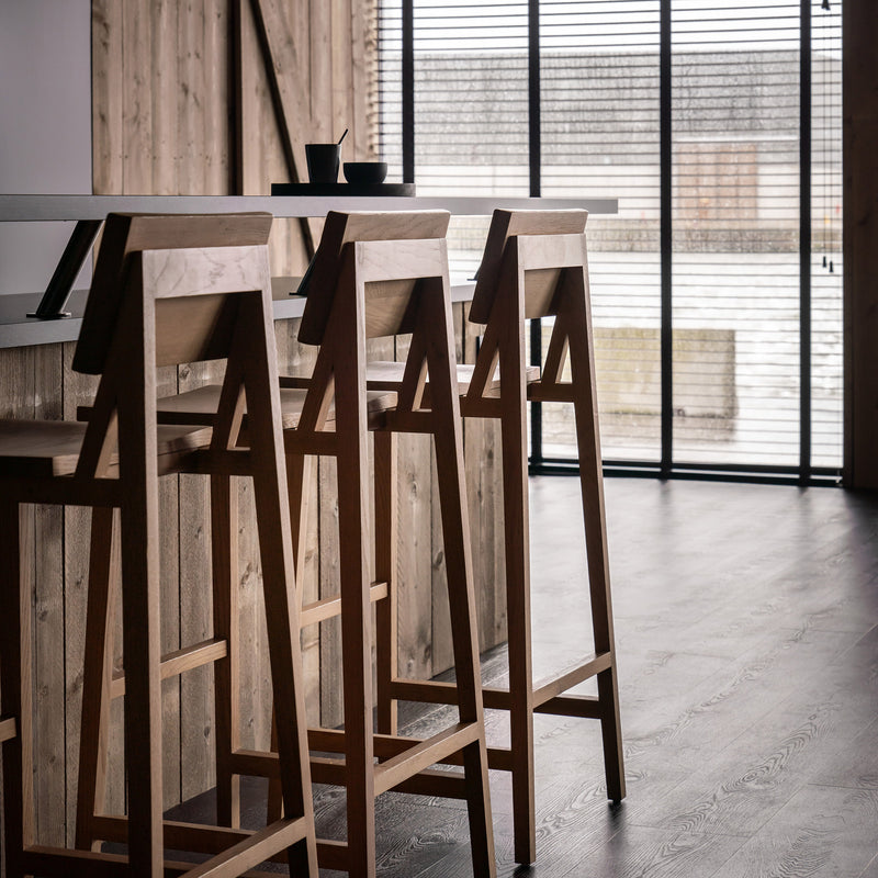 N4 Bar Stool by Ethnicraft, varnished oak bar stools with clean lines in a modern wooden interior setting.