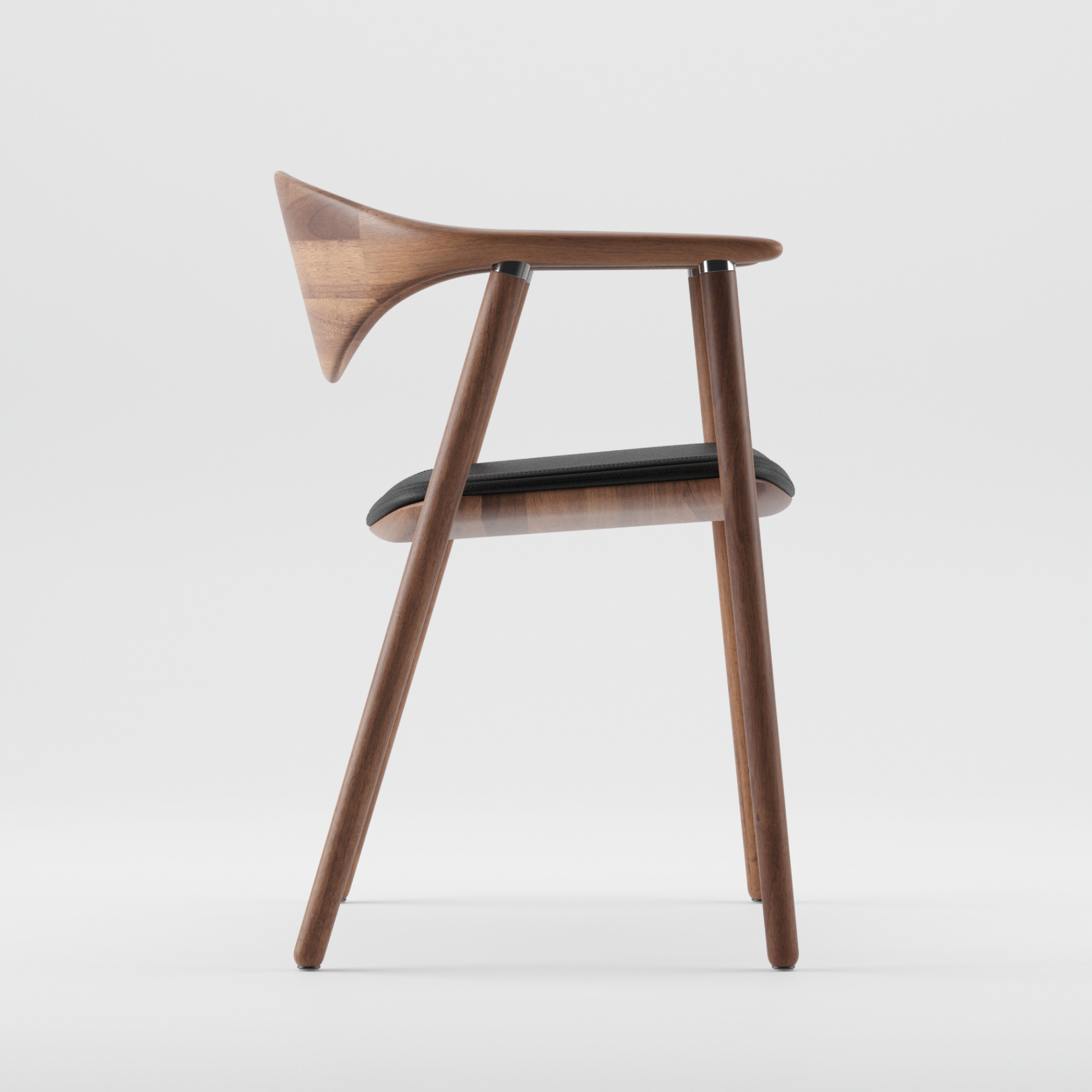 Side view of the Artisan NARU Chair, featuring a minimalist design with three visible legs. Crafted from solid wood, it has a curved backrest and a black upholstered seat enhanced by natural oils, set against a plain white background.