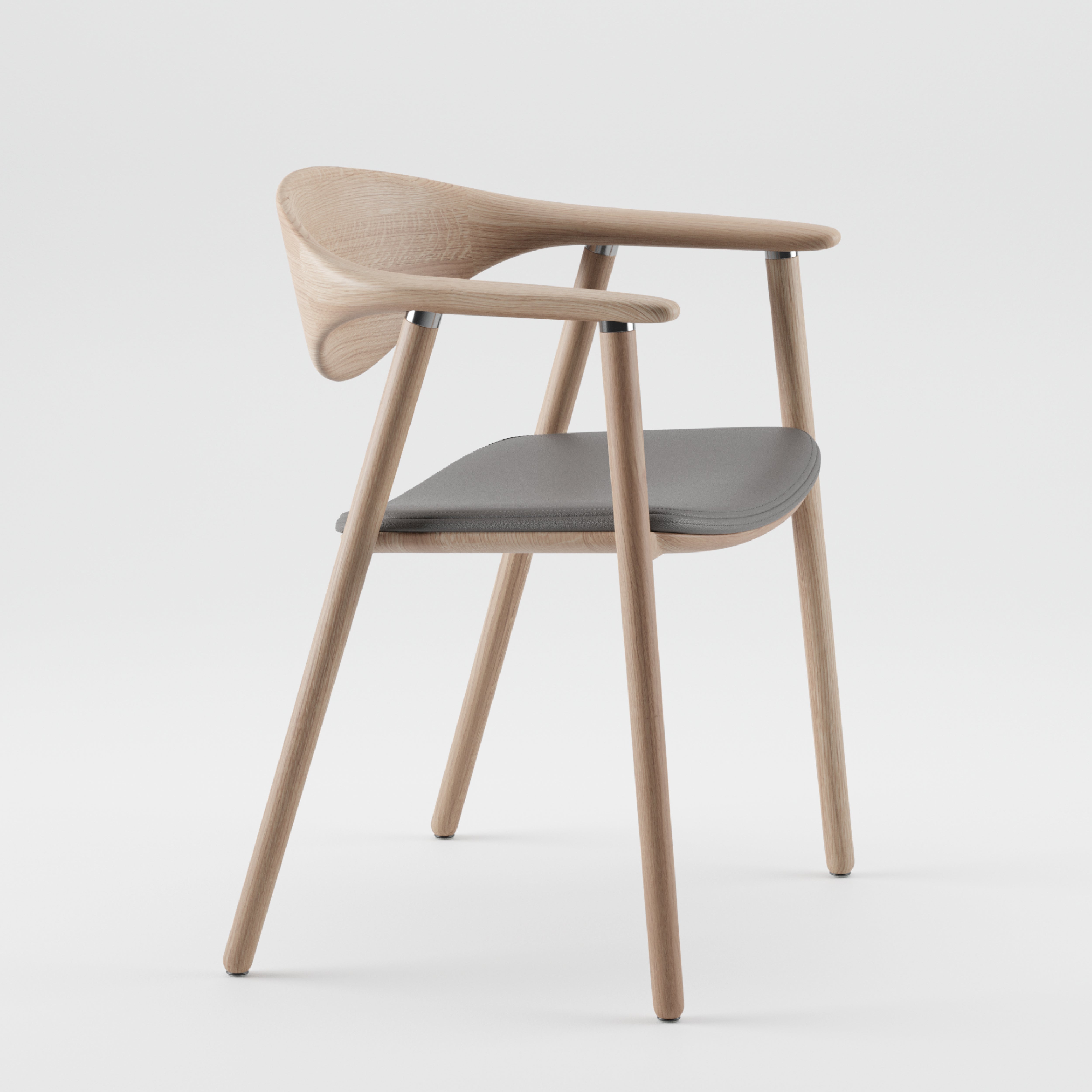 The NARU Chair Upholstered Seat by Artisan is a modern chair made from solid wood with a curved backrest and armrests. It features a sleek design, a gray cushioned seat, four tapered legs, and is crafted from environmentally-friendly materials. The chair is displayed against a plain white backdrop.