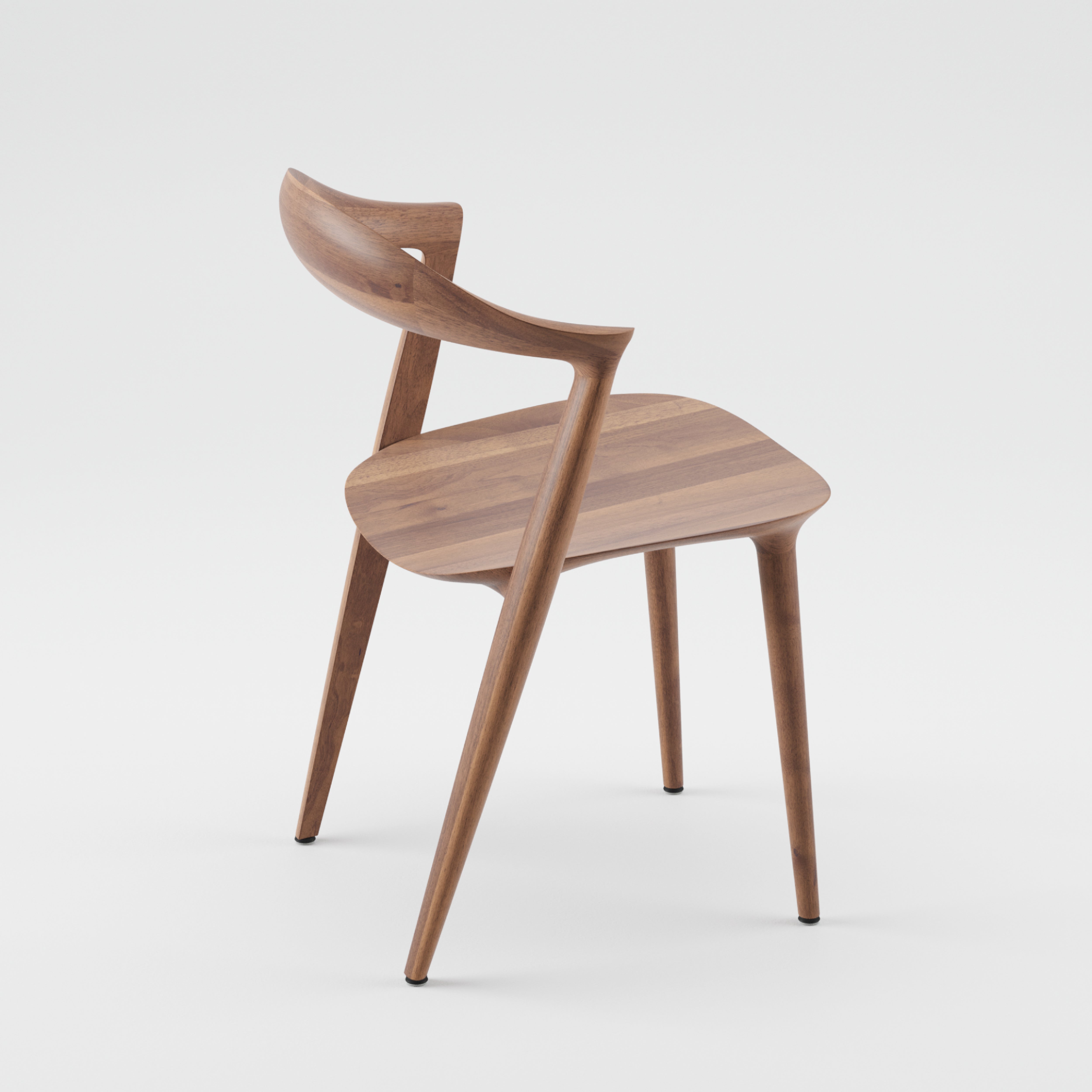 The Addo Chair by Artisan boasts a modern design with a curved backrest and seat, angled legs, and is crafted from solid wood. Finished with natural oils, its sleek and minimalist look stands out against a plain white background.