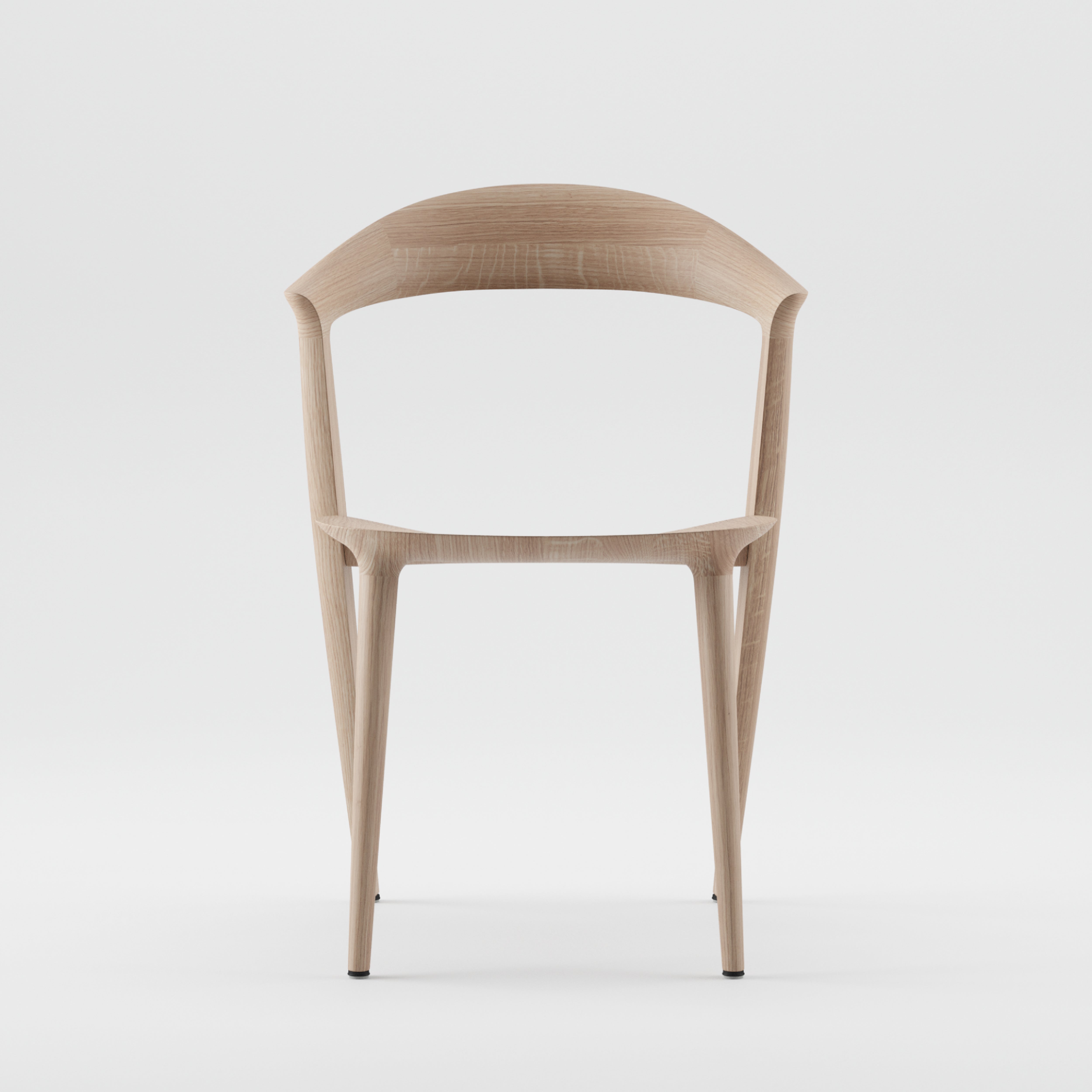 The Addo Chair by Artisan is a minimalist design featuring a solid wood build with a curved backrest and slender legs. Its smooth, natural wood finish, enhanced by oils, offers a contemporary look against a plain white background.