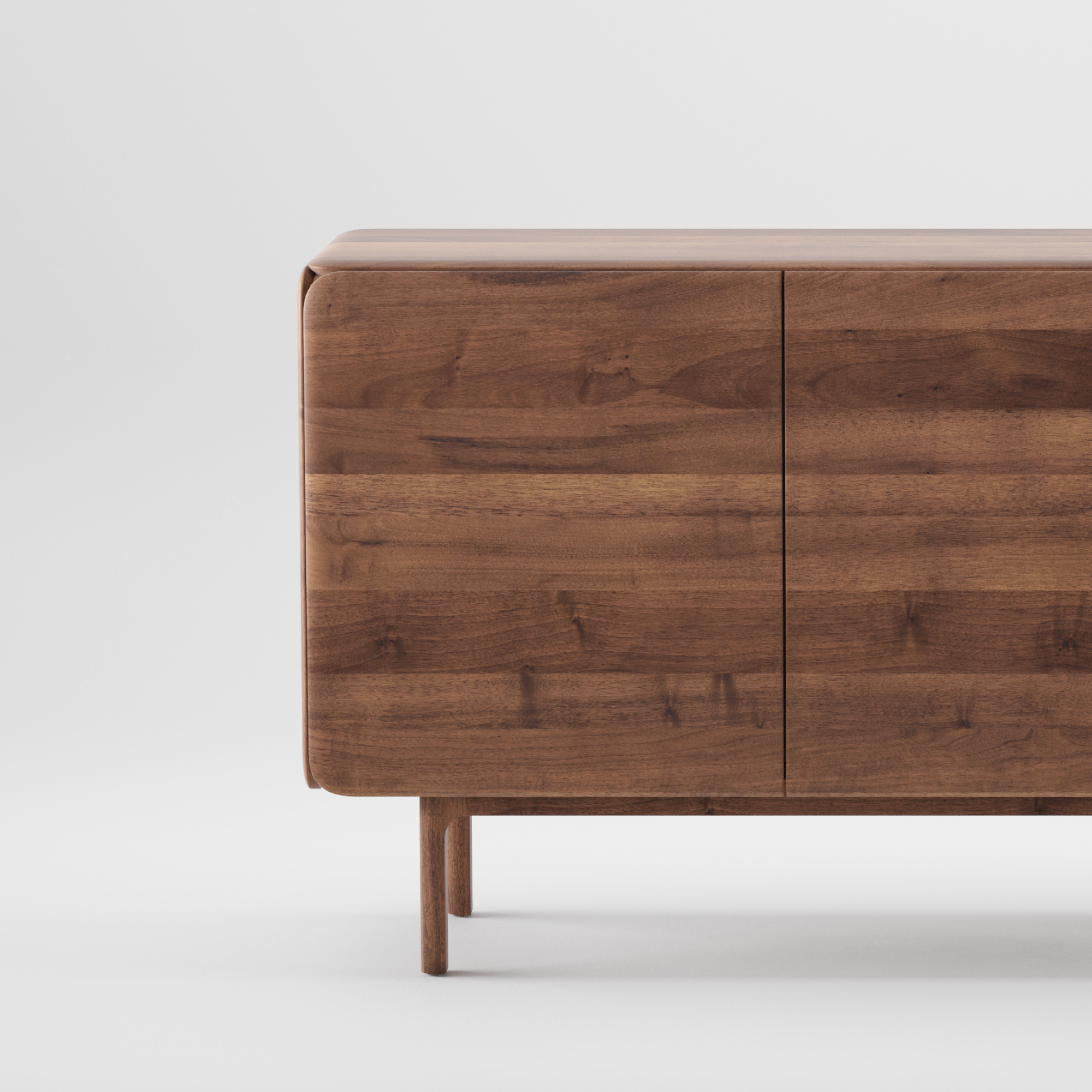 The CLOUD Sideboard by Artisan is crafted from solid wood with a minimalist design, featuring smooth, rounded corners and four short legs. Finished with natural oils, it uses environmentally-friendly materials to enhance its elegant simplicity against a plain white background.