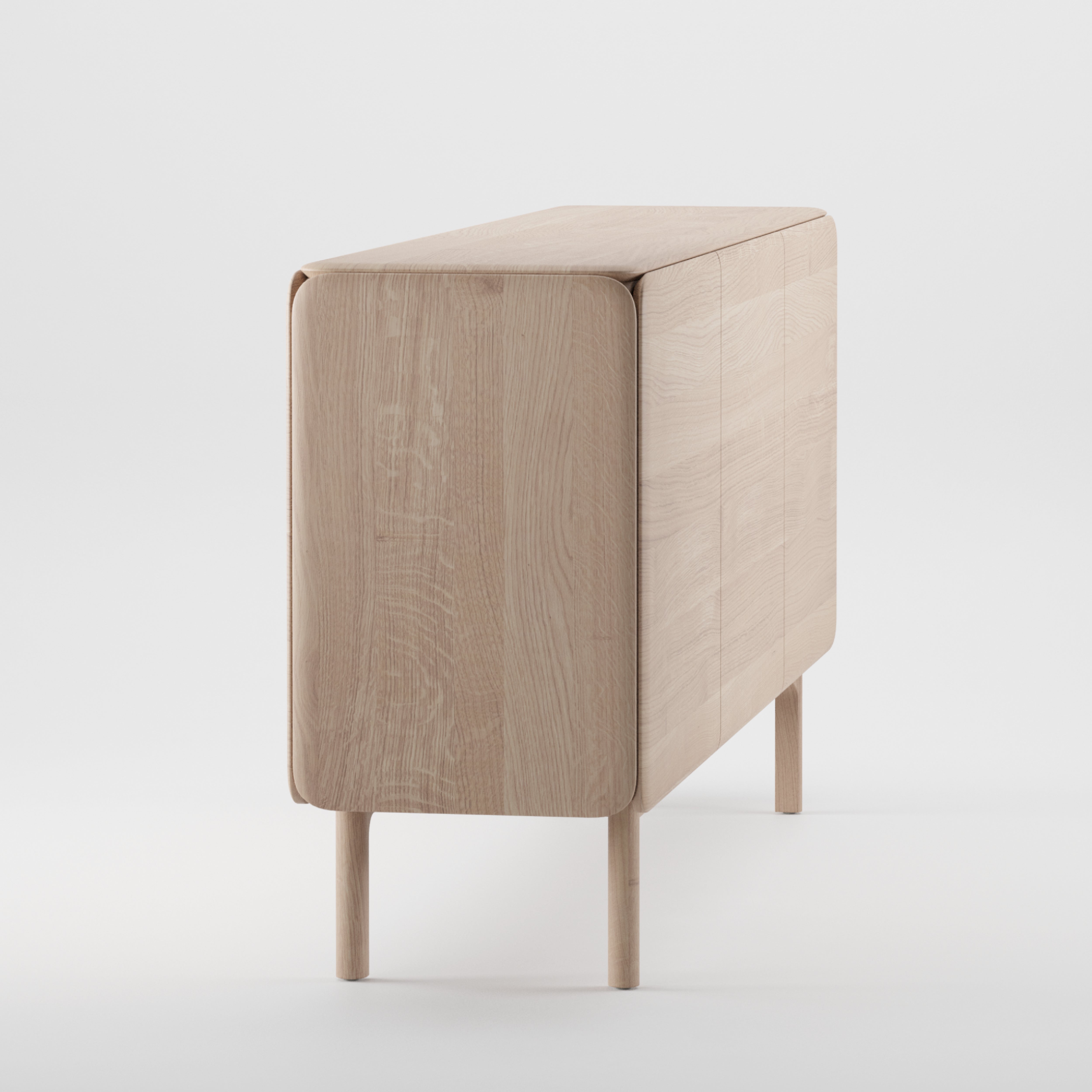 The CLOUD Sideboard by Artisan is a minimalist, light wood cabinet made from solid, eco-friendly materials. It features smooth, rounded edges and stands on four slender legs with clean lines for a modern look. Natural oils enhance its subtle elegance against a plain white background.