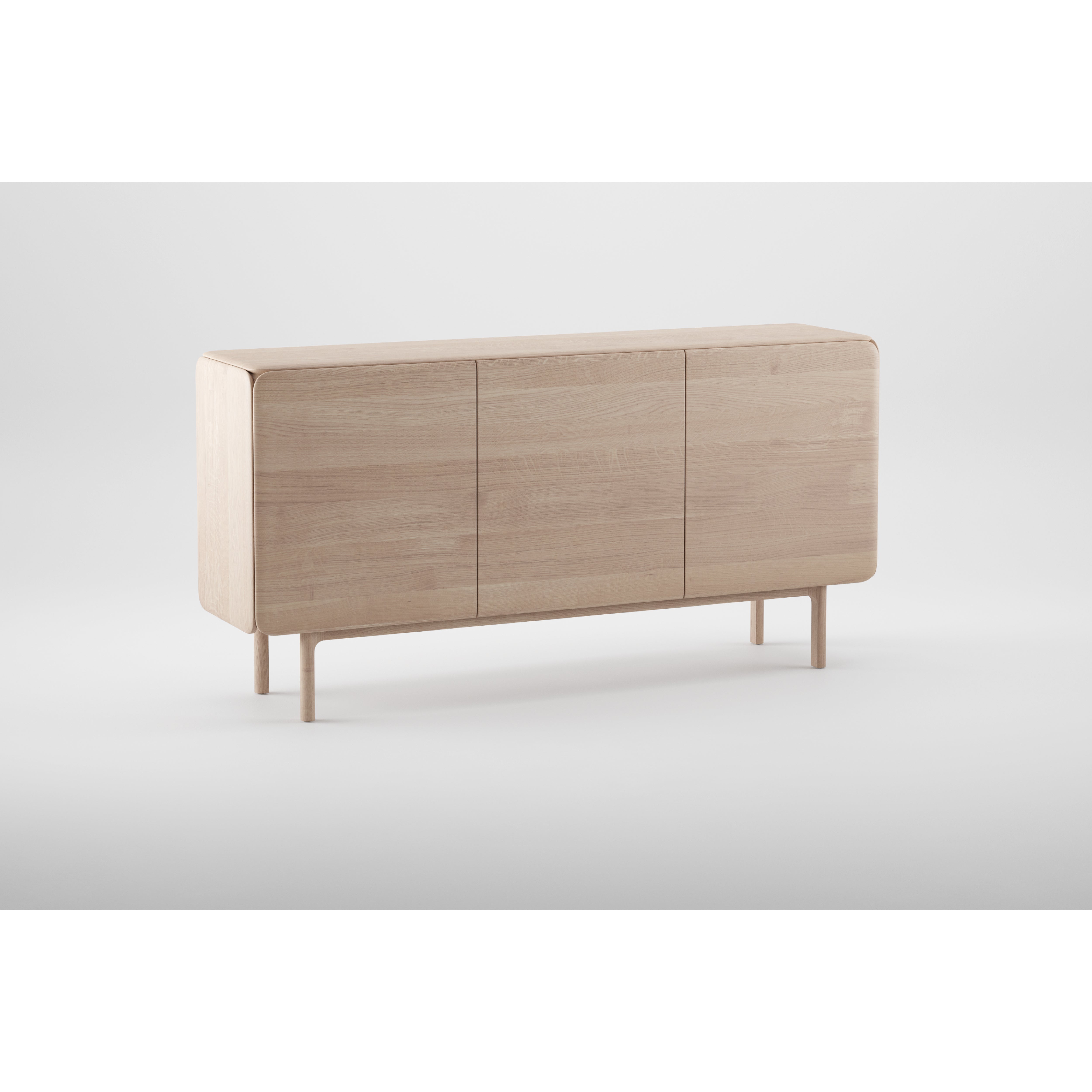 The Artisan CLOUD Sideboard is a minimalist piece, expertly crafted from solid wood with natural oils, featuring three closed compartments and smooth edges. It stands on four short, round legs in a light natural finish against a plain white background.