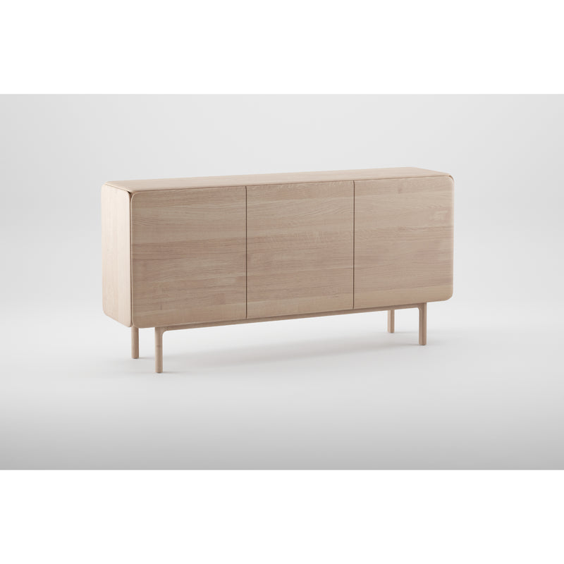 The Artisan CLOUD Sideboard is a minimalist piece, expertly crafted from solid wood with natural oils, featuring three closed compartments and smooth edges. It stands on four short, round legs in a light natural finish against a plain white background.