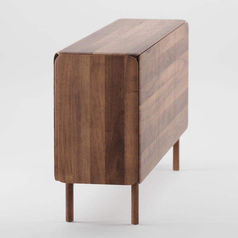 The CLOUD Sideboard by Artisan is a modern piece crafted from solid wood, featuring a minimalist design with a glossy surface enhanced by natural oils. It showcases rich wood grain and stands on cylindrical legs, delivering an eco-friendly aesthetic.