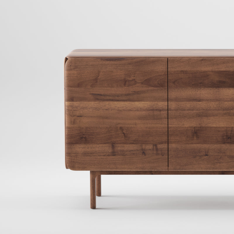 The CLOUD Sideboard by Artisan is crafted from solid wood with a minimalist design, featuring smooth, rounded corners and four short legs. Finished with natural oils, it uses environmentally-friendly materials to enhance its elegant simplicity against a plain white background.