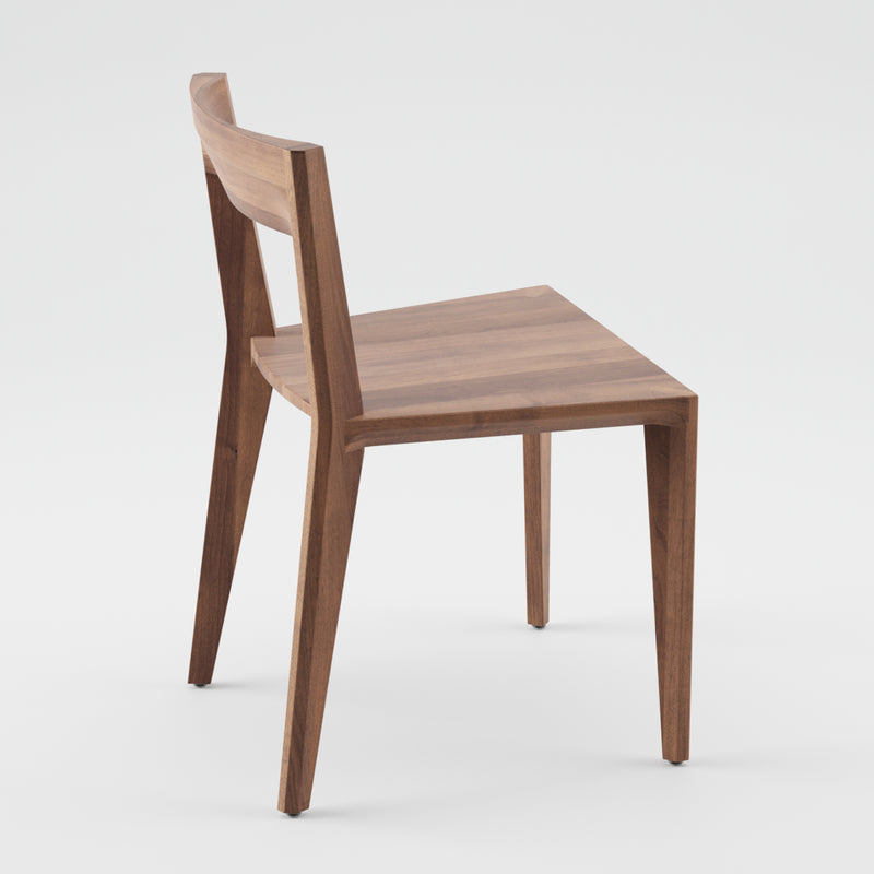 The HANNY Chair by Artisan boasts a minimalist design, crafted from solid wood with a straight backrest and slightly angled legs. Enhanced with natural oils, it sits on a plain white background, embodying eco-friendly materials.
