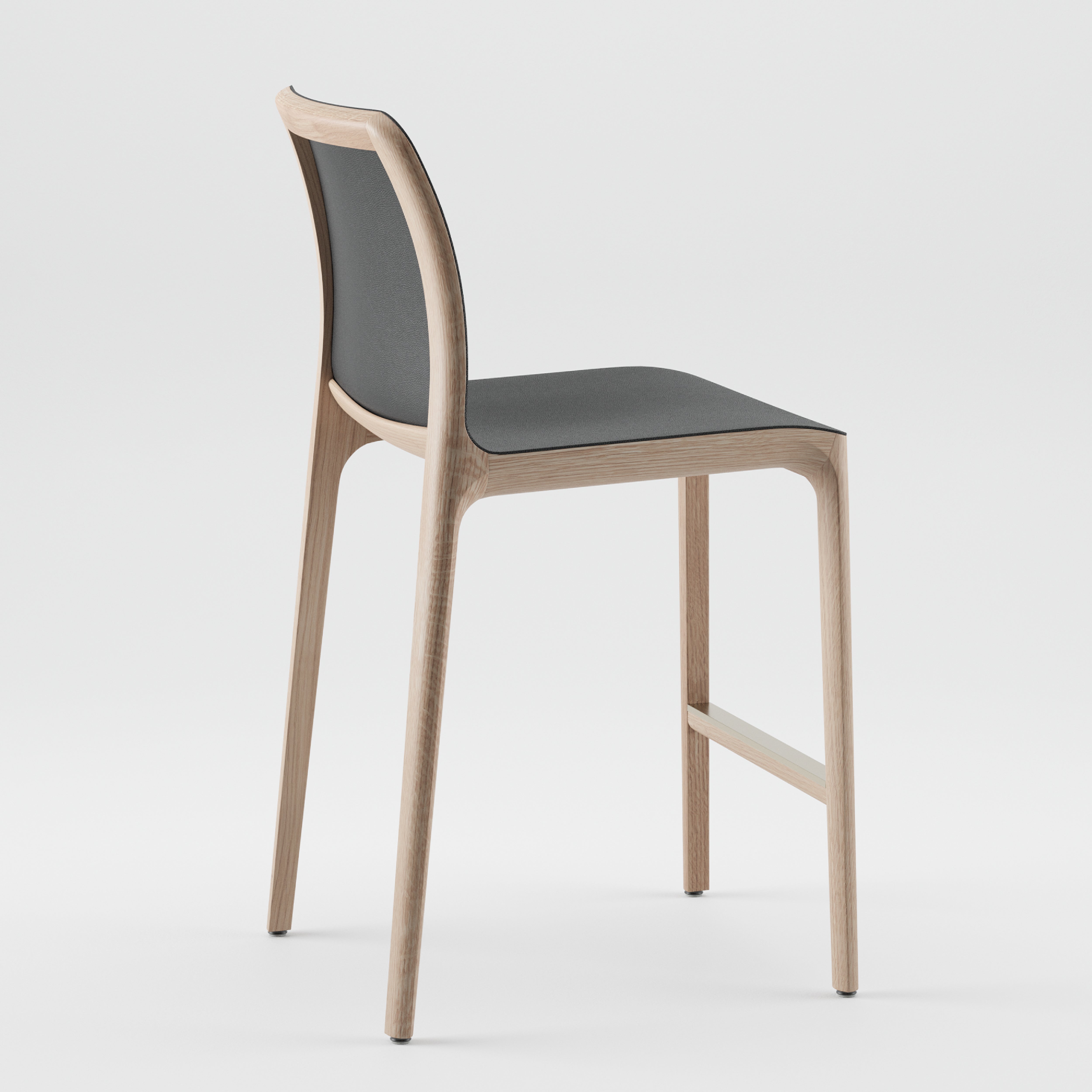 The INVITO Barstool by Artisan features a solid wood frame, dark cushioned seat, minimalist design, and a footrest. Its elegantly displayed against a plain white background.