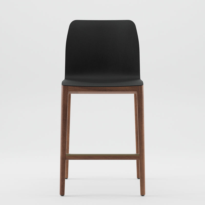 The INVITO Barstool by Artisan features a sleek black seat with an artisan designer wooden frame made from eco-friendly materials. Its minimalist design includes a footrest connecting the legs, showcased against a plain white background to highlight its contemporary style.