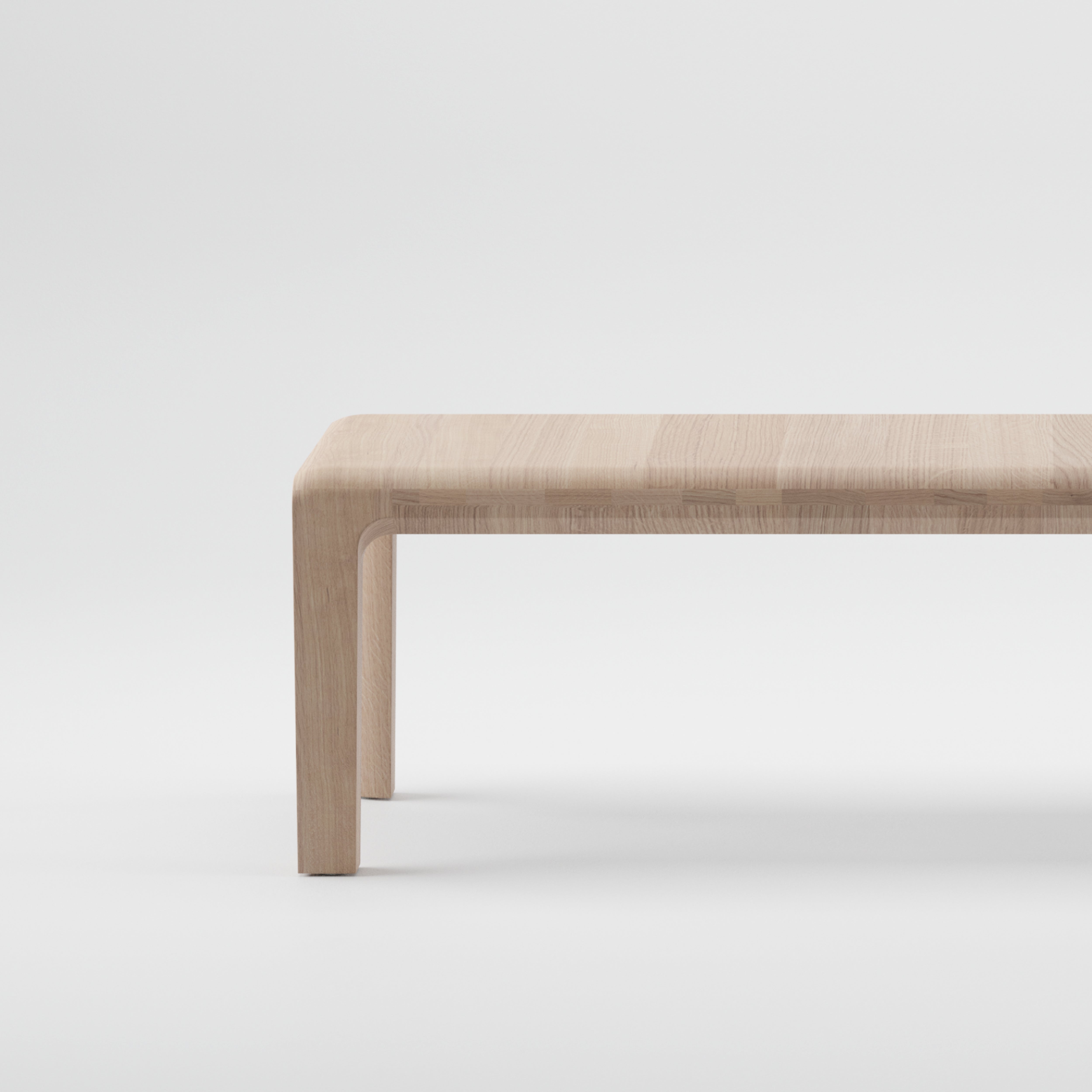 The Artisan INVITO Bench is a minimalist piece featuring a smooth surface and curved edges, crafted from environmentally-friendly solid wood, and presented against a plain white background.