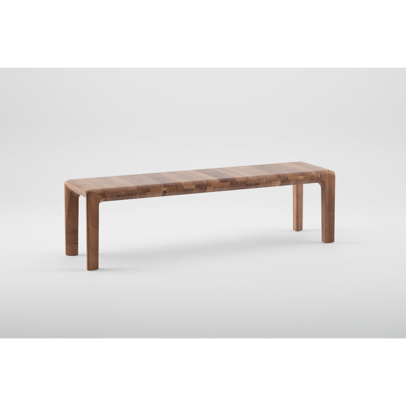 The INVITO Bench by Artisan is a minimalist wooden bench with a sleek modern design, featuring curved legs and a striped seat. Crafted from solid wood and finished with natural oils, its displayed against a plain white background.
