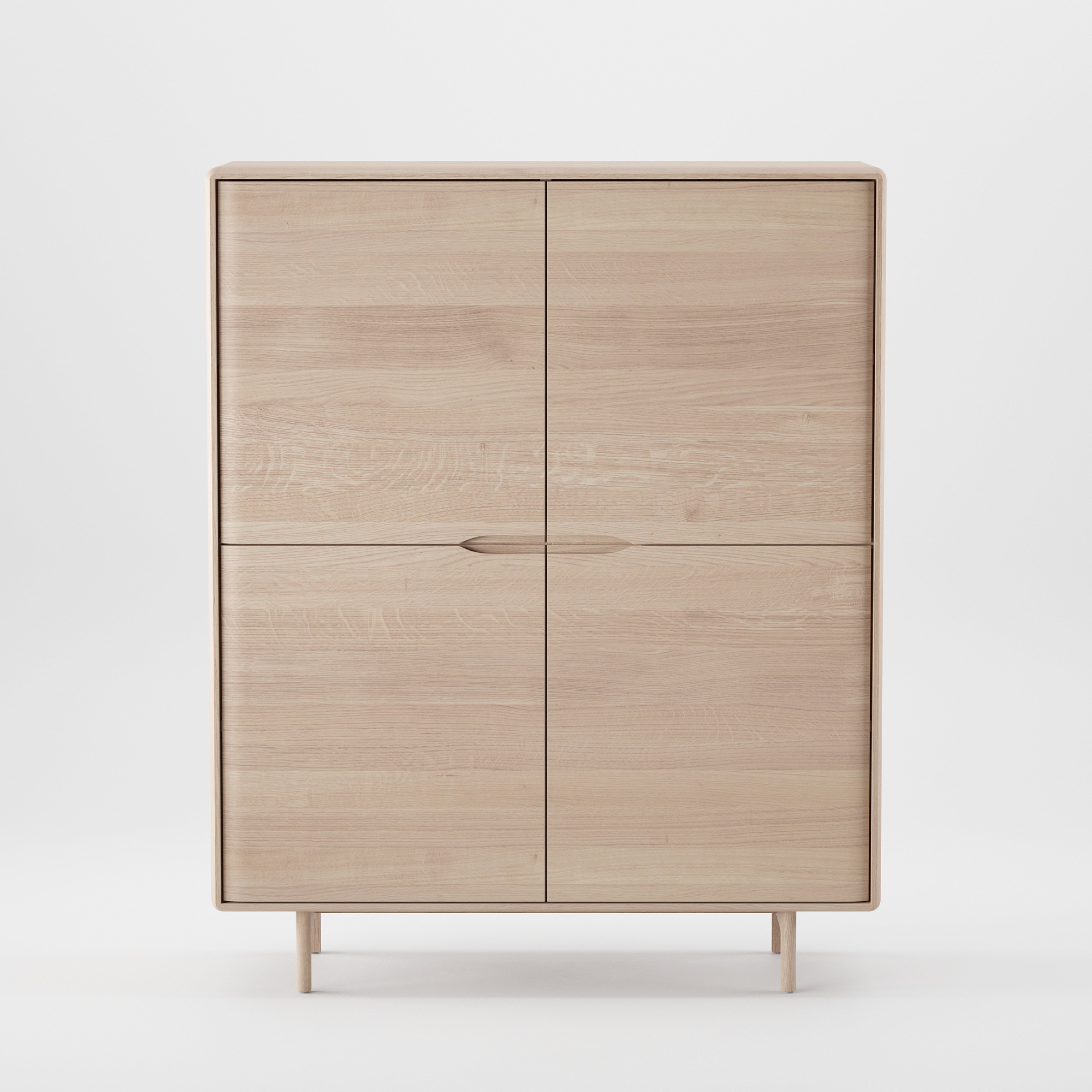 The INVITO Highboard by Artisan is a minimalist cabinet crafted from solid wood, finished with natural oils. Against a white background, its four doors feature simple vertical handles, showcasing an eco-friendly design that combines sleekness and modernity.
