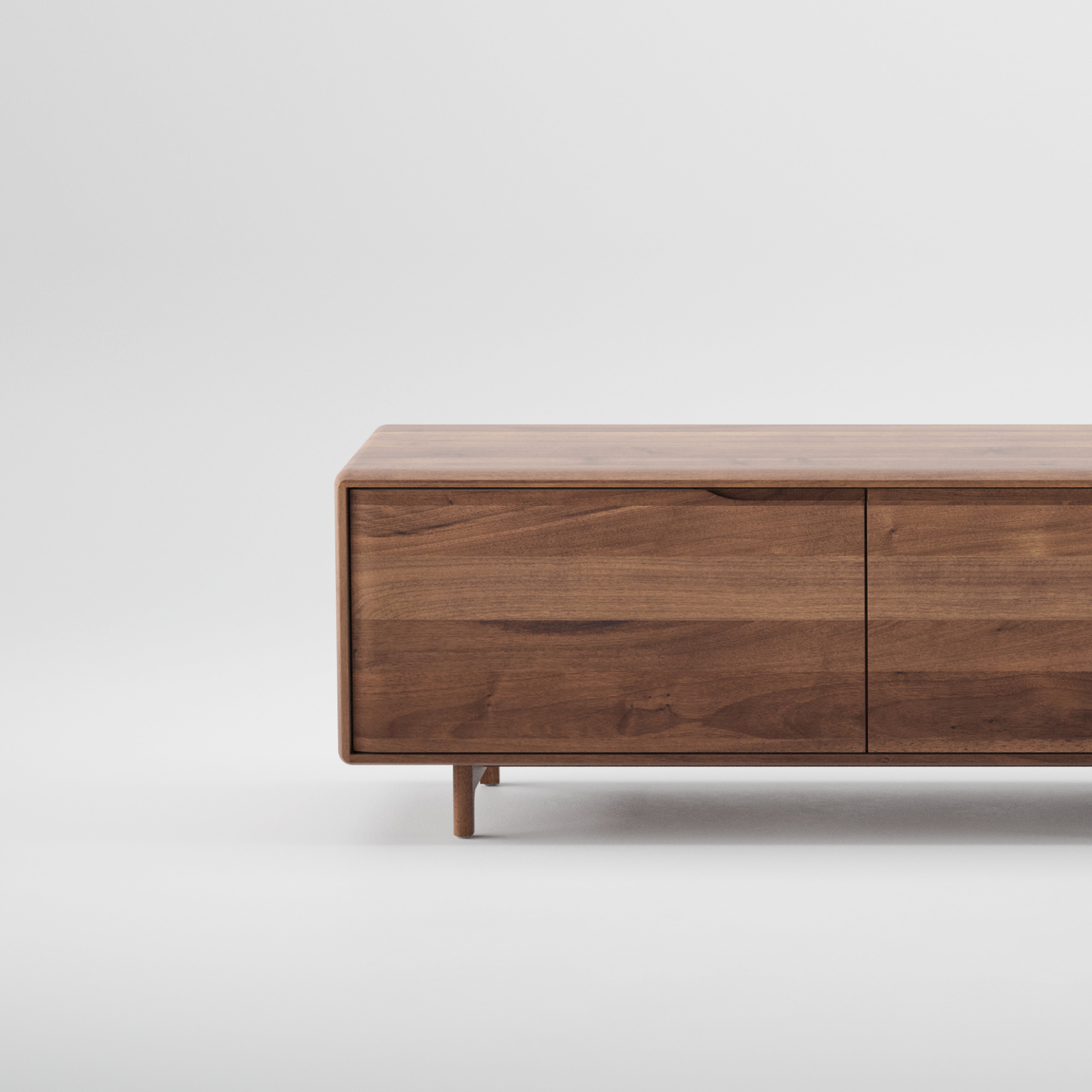 The Artisan INVITO Lowboard is a minimalist wooden TV stand made from solid wood, coated with natural oils, and featuring two doors. Set on a plain white background, it showcases a smooth finish and elegant lines crafted from eco-friendly materials.