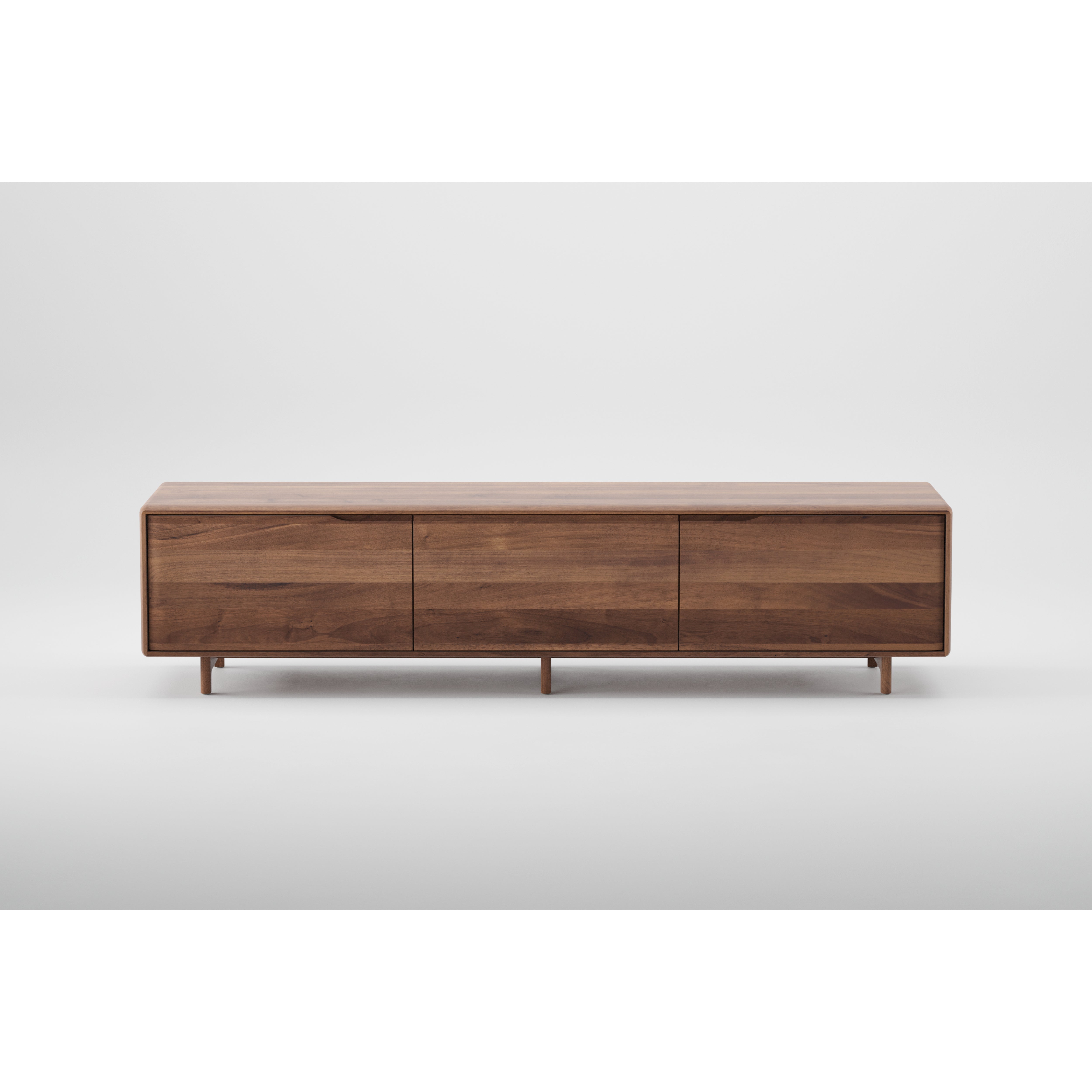 The Artisan INVITO Lowboard is a sleek, modern piece made from solid wood with a smooth finish. Enhanced with natural oils, it features three drawers and stands on short legs, showcased against a plain white background.