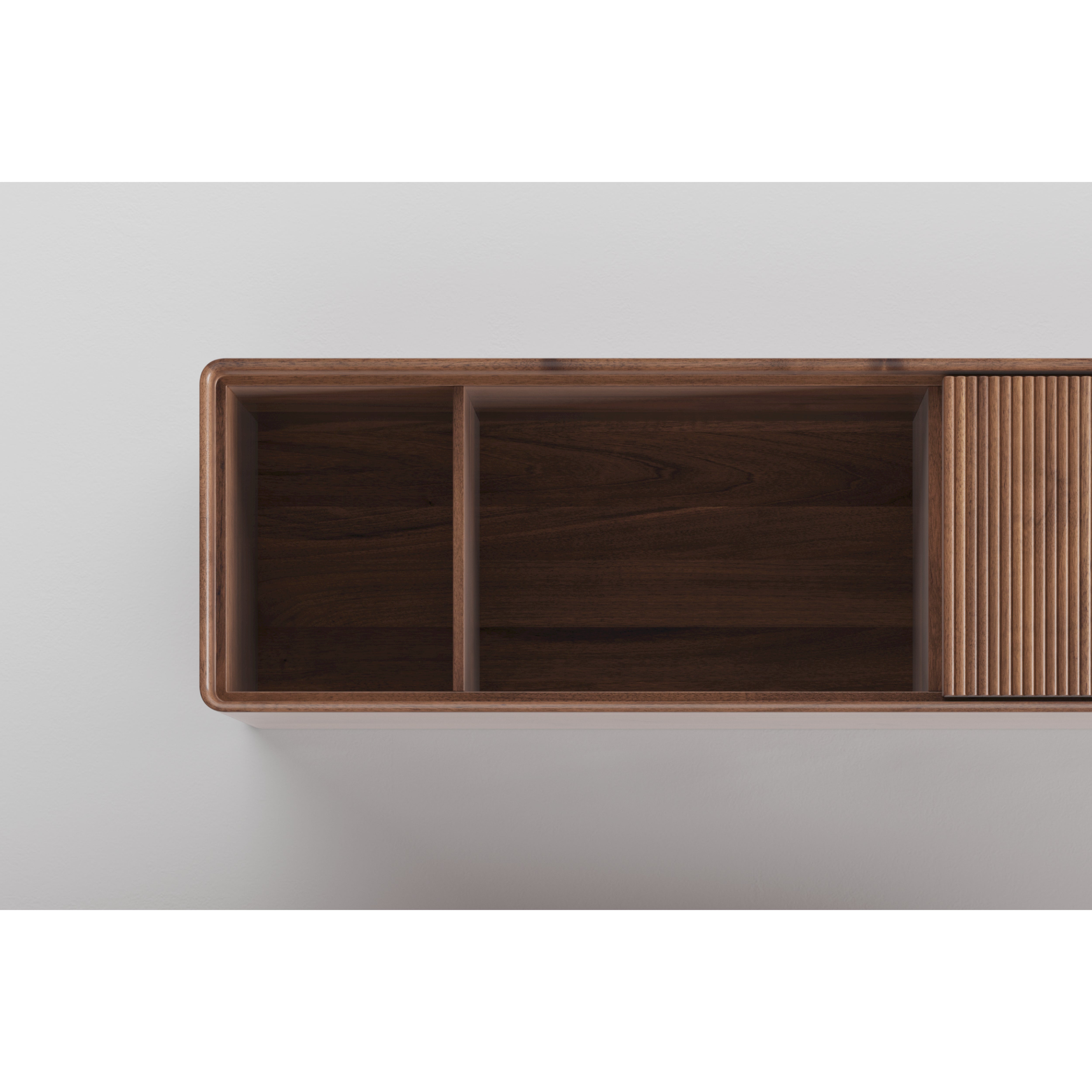 Top view of the JANTAR Modular System by Artisan, a solid wood wall shelf featuring three open compartments on the left and a vertical slatted door section on the right. Finished with natural oils, this eco-friendly piece is mounted against a white background.
