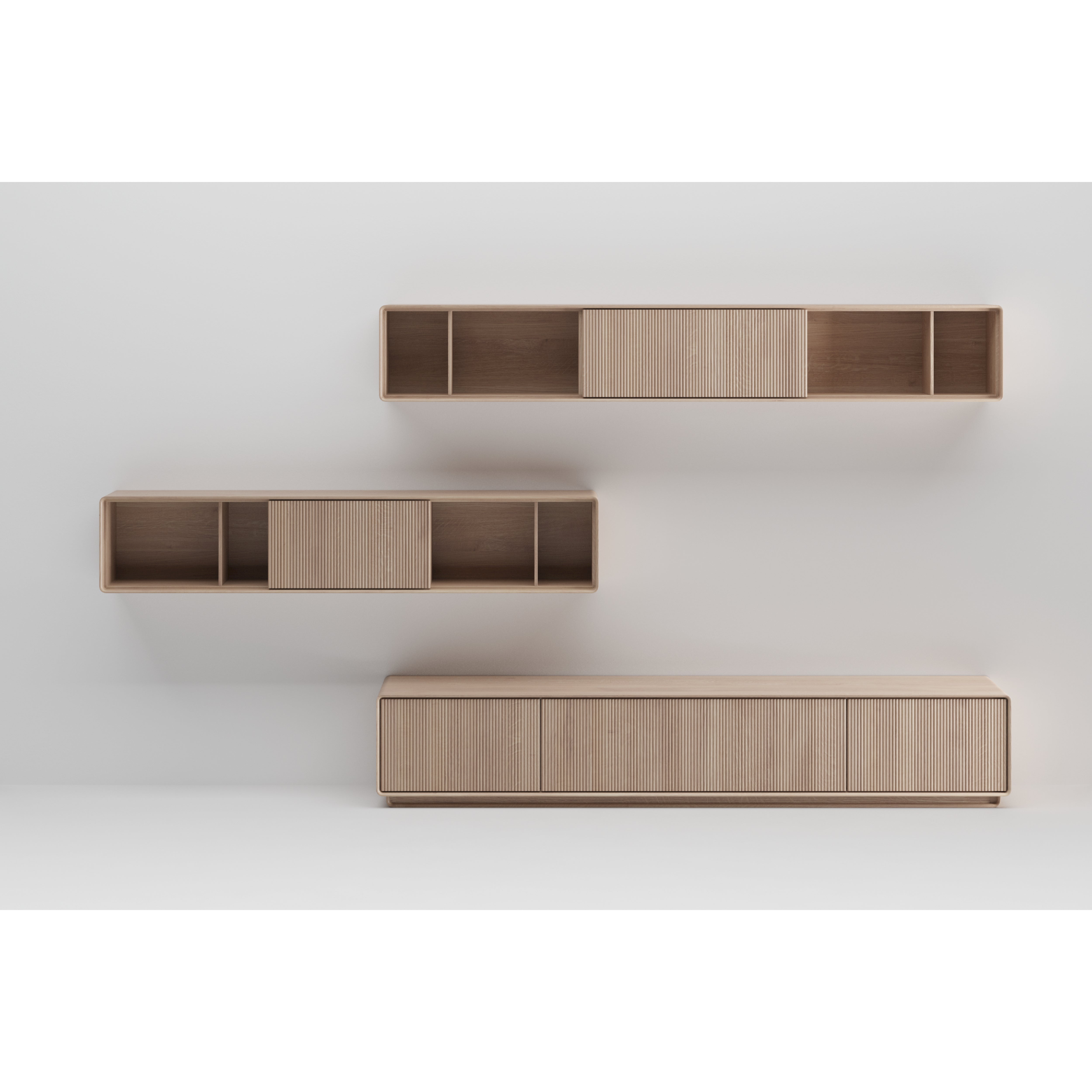 The JANTAR Modular System by Artisan is a minimalist wooden storage unit against a light wall, crafted from solid wood and finished with natural oils. It includes a large base cabinet with horizontal lines, plus two floating shelves with open compartments and small sliding doors.