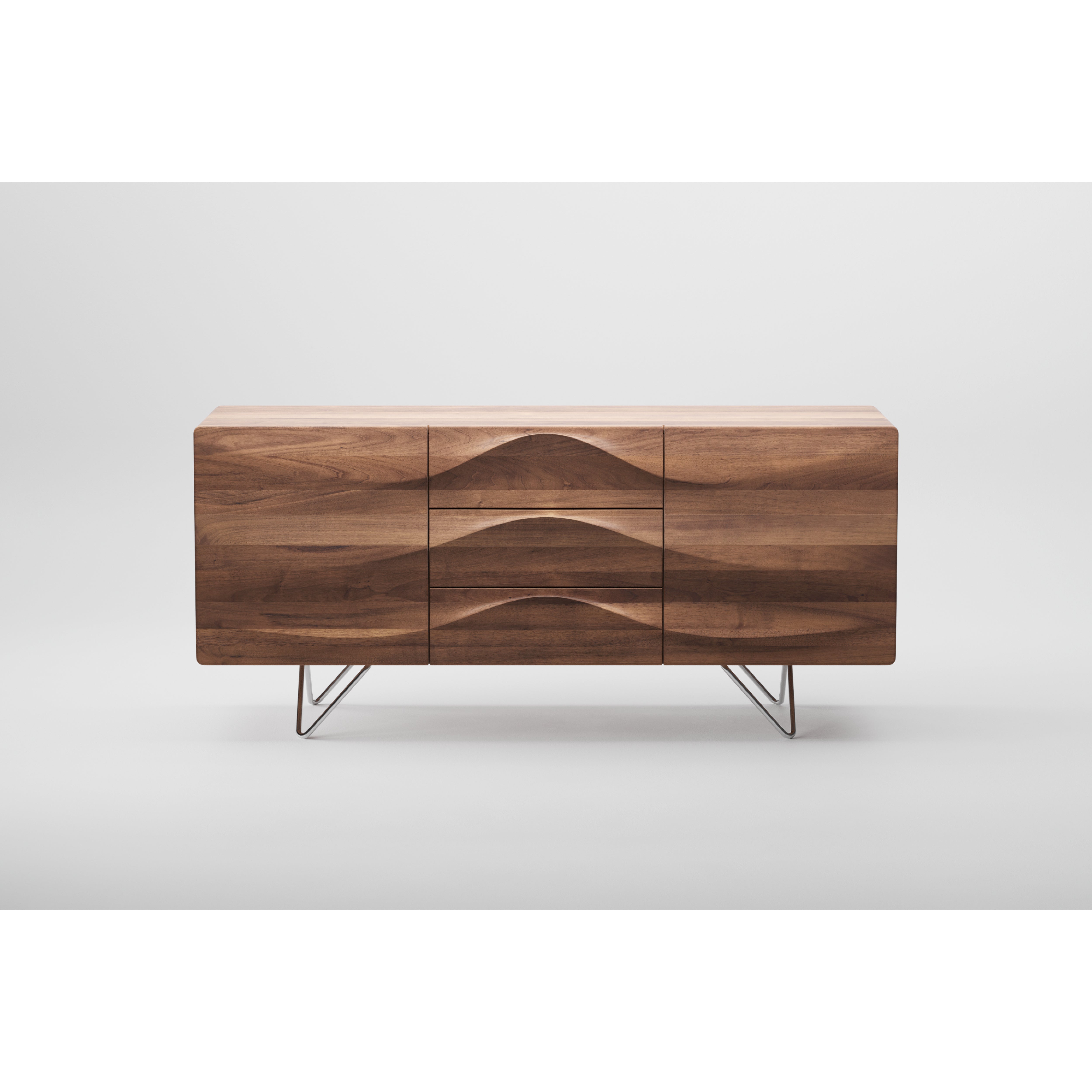 The LASTA Sideboard by Artisan is a modern, environmentally-friendly piece crafted with natural oils. It features a wave pattern, three drawers, and two cabinet doors. Elevated on minimalist metal legs, this solid wood sideboard is set against a plain white background.
