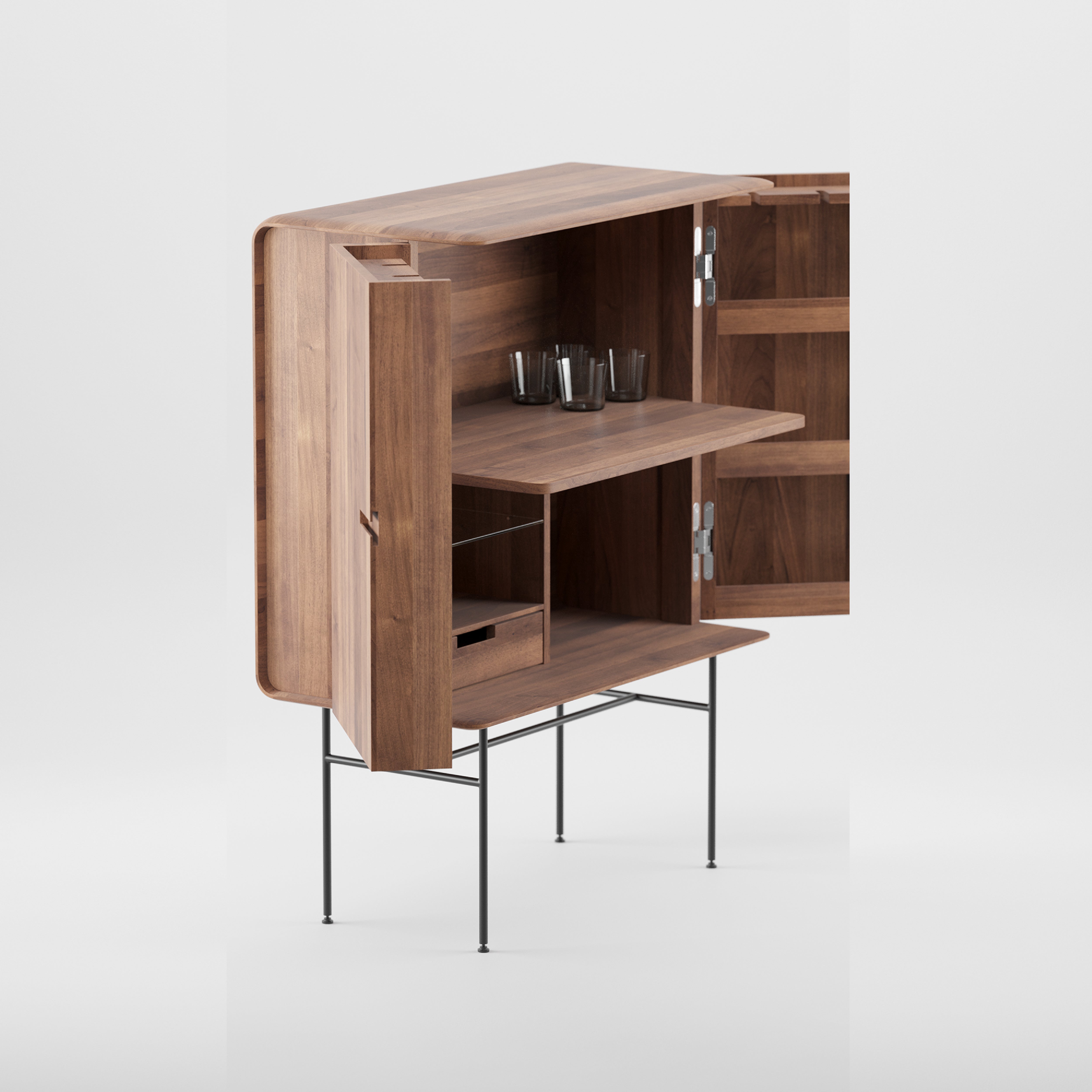 The Leno Bar by Artisan features an open wooden cabinet with rounded edges, two shelves, and a drawer inside. Made from solid wood, it stands on slender metal legs. Three clear glasses sit on the middle shelf, highlighting its modern design against a plain white background.