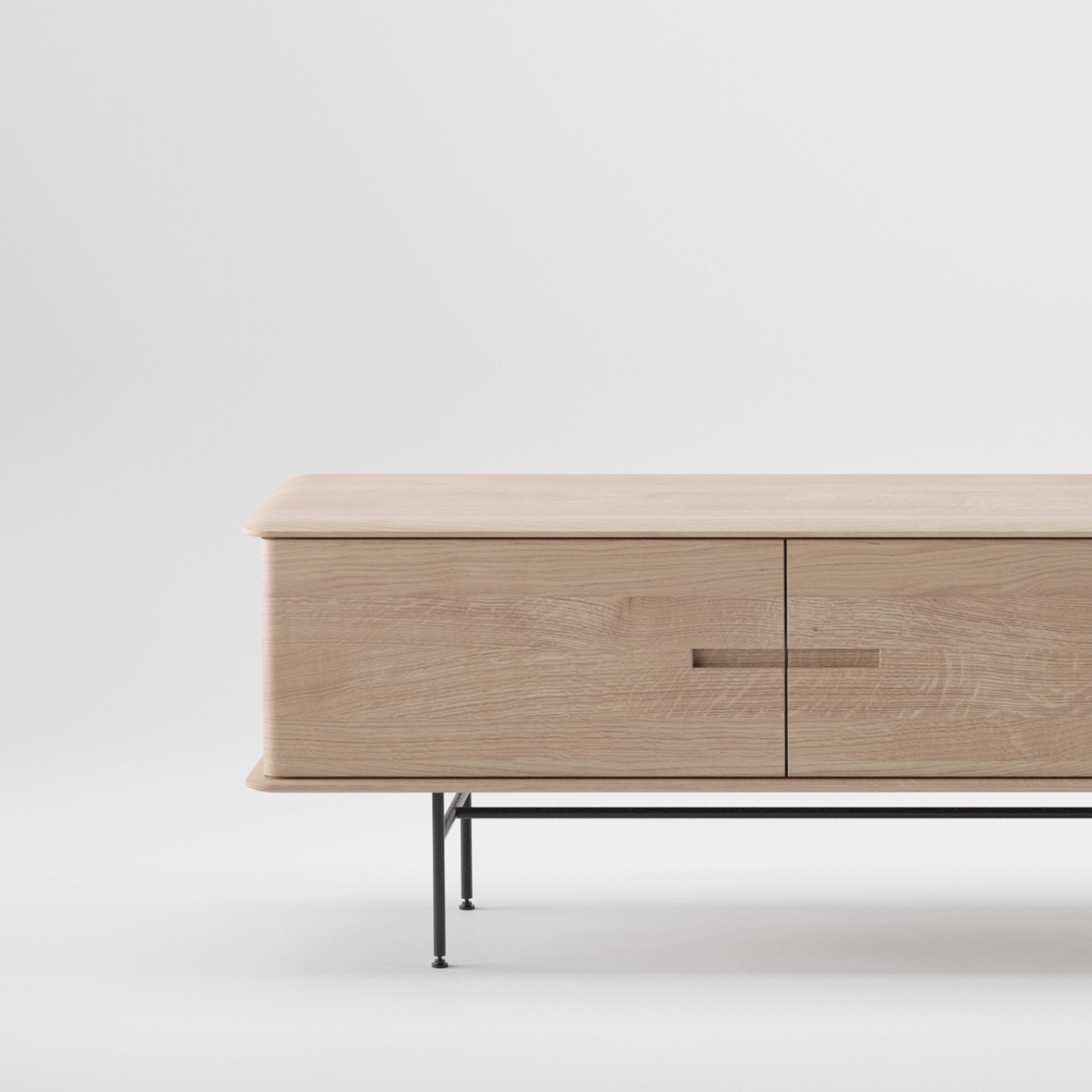The Artisan Leno Sideboard, featuring a modern design with a light wood finish, stands elegantly on sleek black metal legs. Crafted from solid wood, its minimalist form is beautifully showcased against a plain white background.