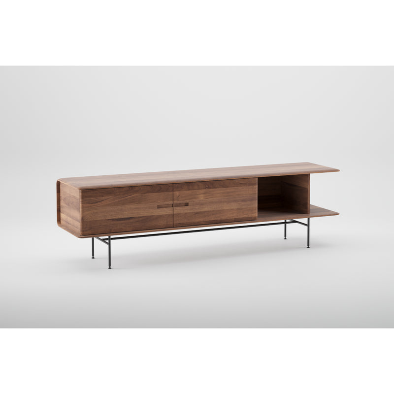 The Leno Sideboard by Artisan is a modern wooden TV stand made from solid wood, featuring a sleek minimalist rectangular design with a smooth surface, two closed cabinets, an open shelf, and thin black metal legs.