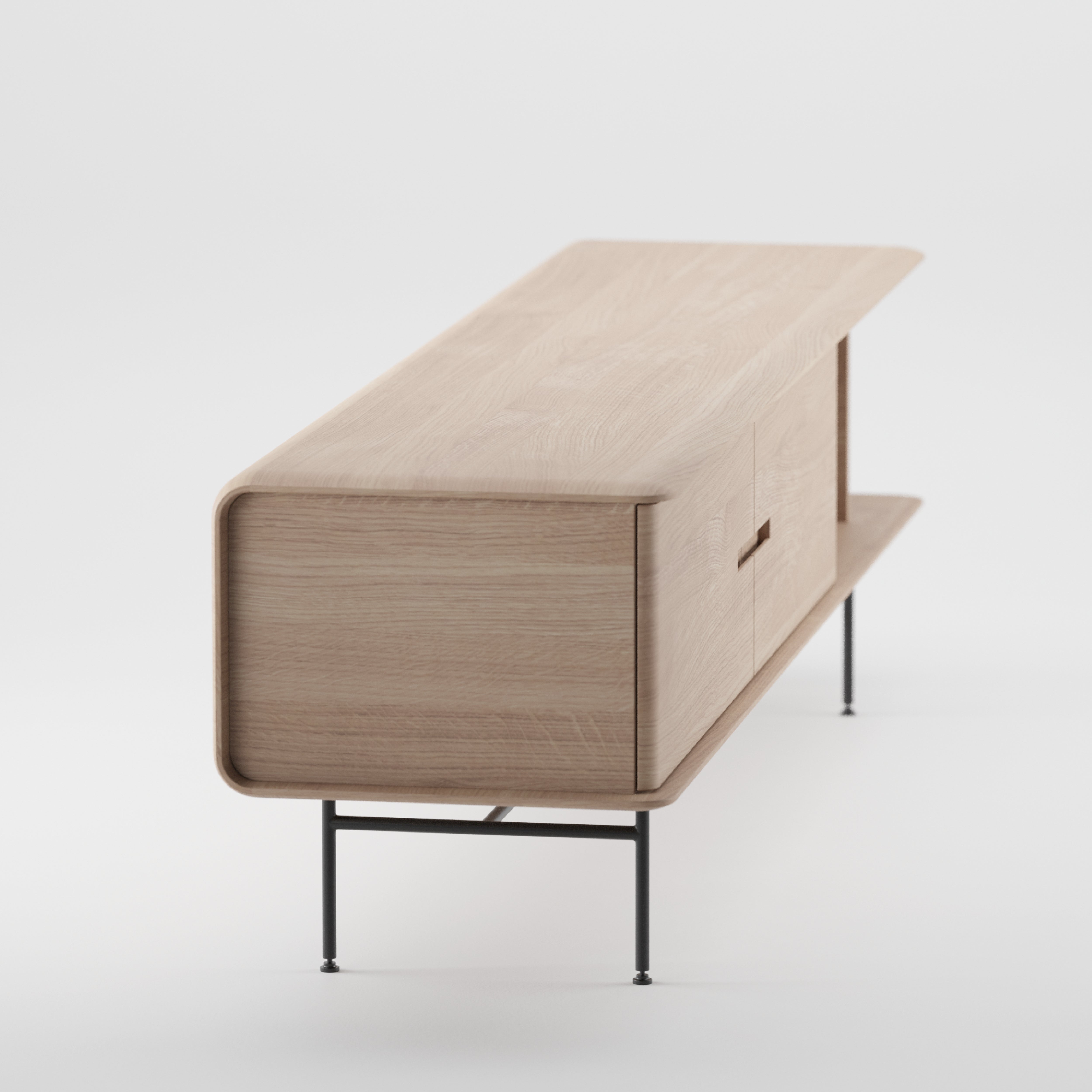 The Leno Sideboard by Artisan is a modern wooden piece featuring sleek, rounded edges on thin black metal legs. Crafted from solid wood, its minimalist design emphasizes simplicity and elegance, with a streamlined profile view.