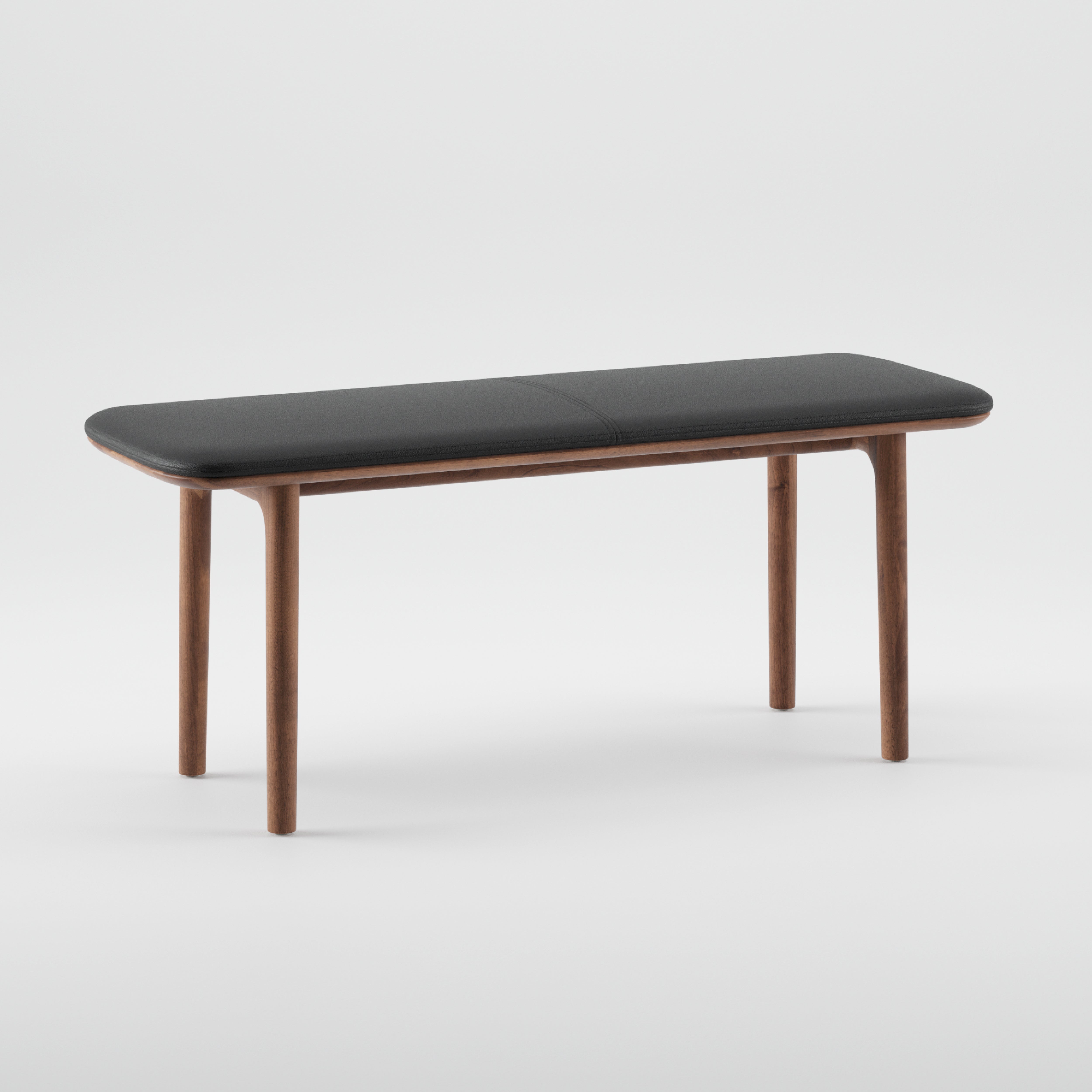 The NEVA Bench by Artisan showcases a contemporary design with a dark cushioned seat and sleek wooden legs, highlighted against a white background with organic wood forms.