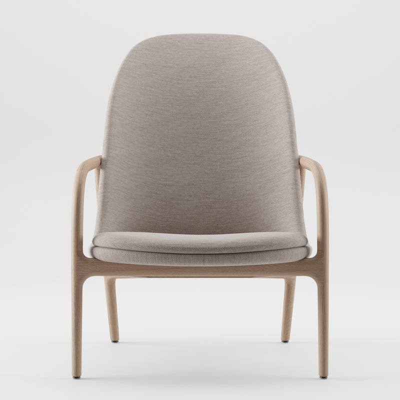 The NEVA Lounge Chair High by Artisan showcases a minimalist design with a curved, light gray fabric backrest and seat, complemented by sleek wooden armrests and legs, exemplifying Scandinavian craftsmanship against a white backdrop.