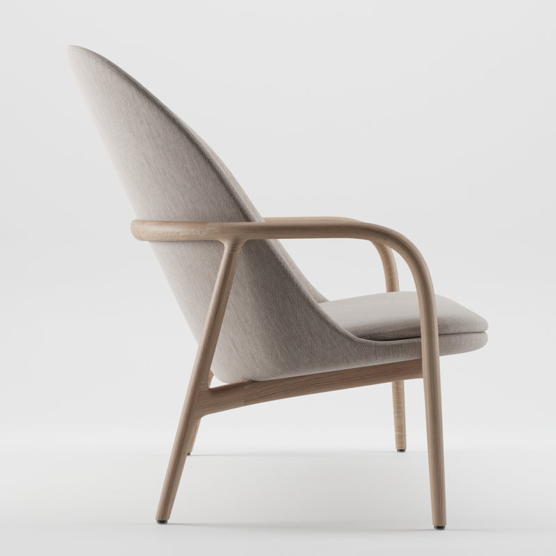 Side view of the Artisan NEVA Sofa with a tall, angled backrest and sleek wooden frame. Inspired by Scandinavian design, its upholstered in light grey fabric for a minimalist and elegant look. Set against a plain white background.