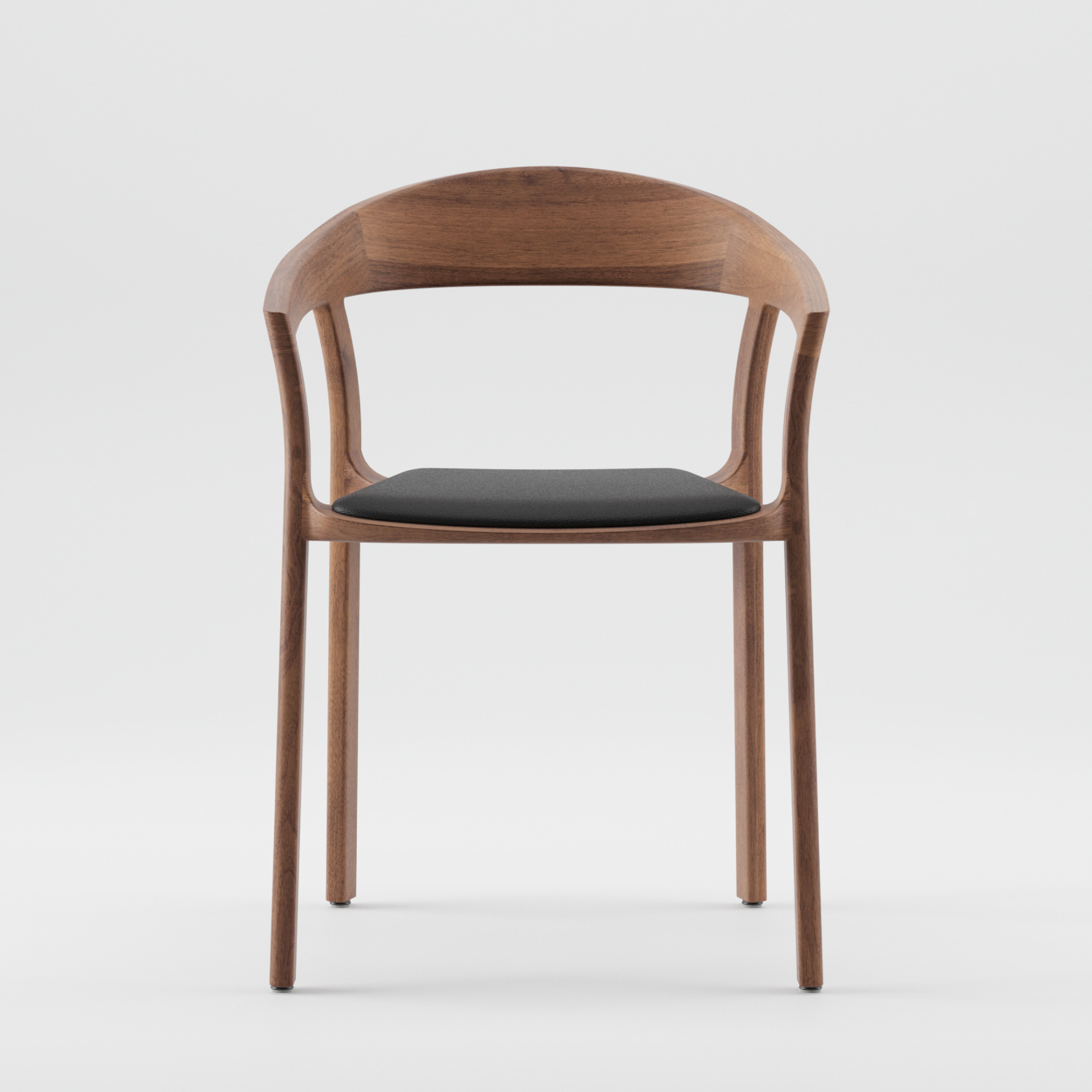 The TARA Armchair by Artisan is crafted from solid wood with a curved backrest and armrests. It has a dark cushioned seat, offering a minimalist modern design, made with eco-friendly materials. Positioned on a plain white background.