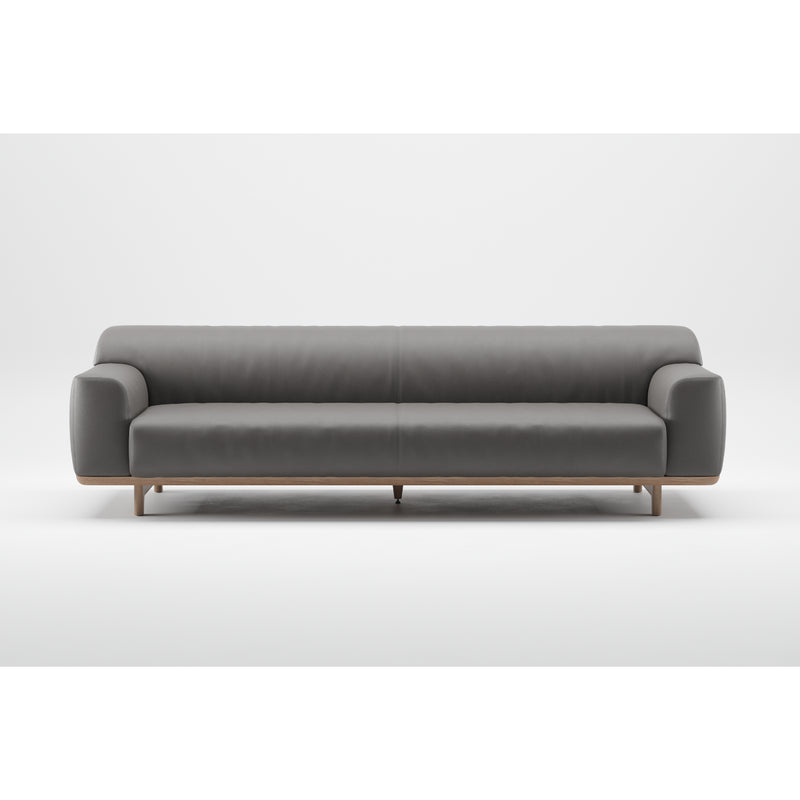 The Tara Sofa by Artisan is a modern, gray sofa featuring a minimalist design with curved armrests and a solid wood base and legs. Crafted from eco-friendly materials, it is displayed against a plain white background.