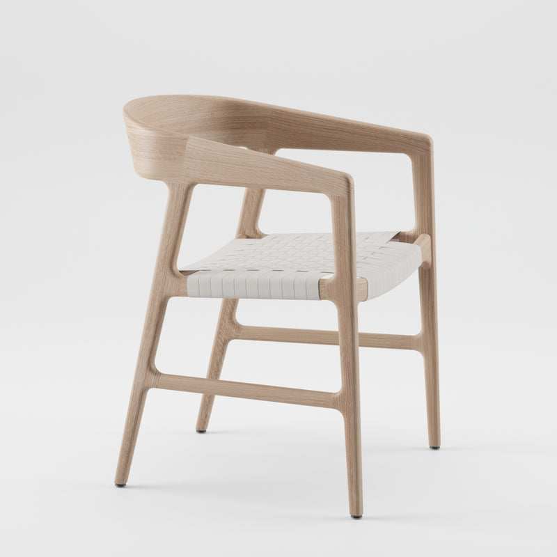 The Artisan TESA Chair is a wooden seat with a modern design, featuring a curved backrest and an environmentally-friendly woven white seat, set against a plain white background.