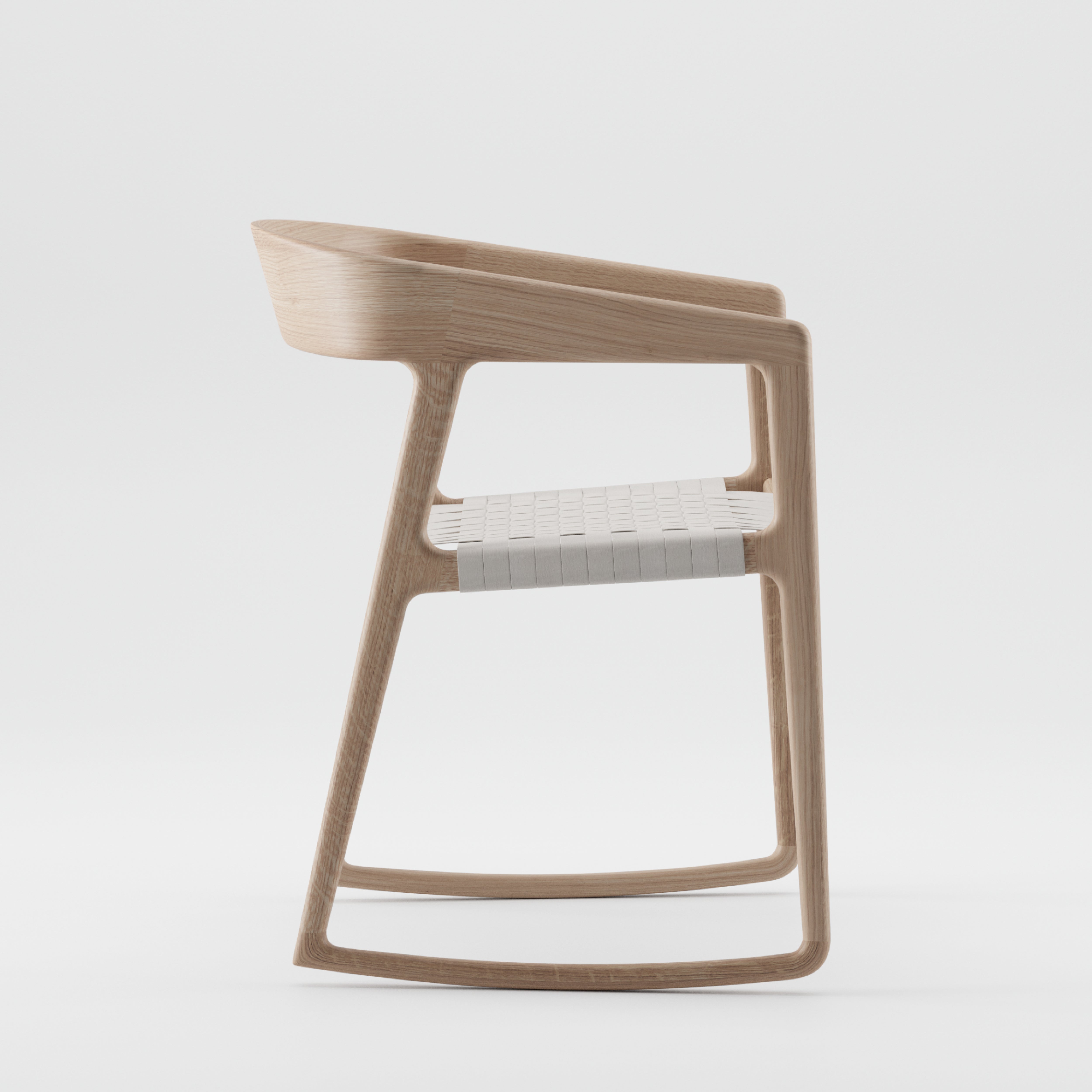 Side view of Artisans TESA SWING CHAIR, a modern wooden chair with a sleek design. Crafted from solid wood, it features a curved backrest and woven seat reflecting minimalist style, finished with natural oils for eco-friendliness, all against a plain white background.