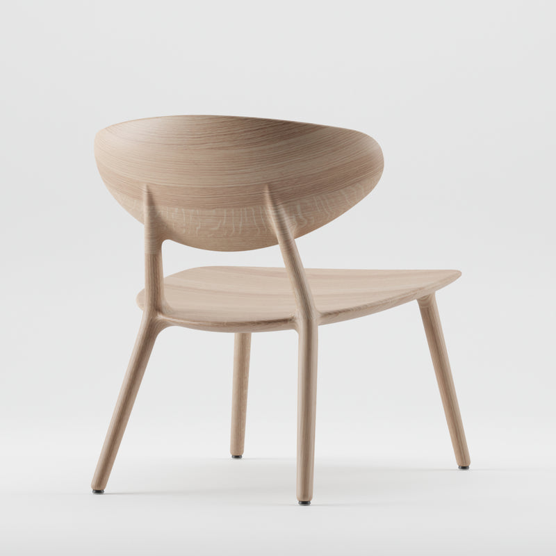 The Artisan WU Lounge Chair is a minimalist wooden piece featuring a curved backrest and angled legs, crafted from solid wood. It boasts smooth lines and luxurious wood texture, complemented by a plain white background.