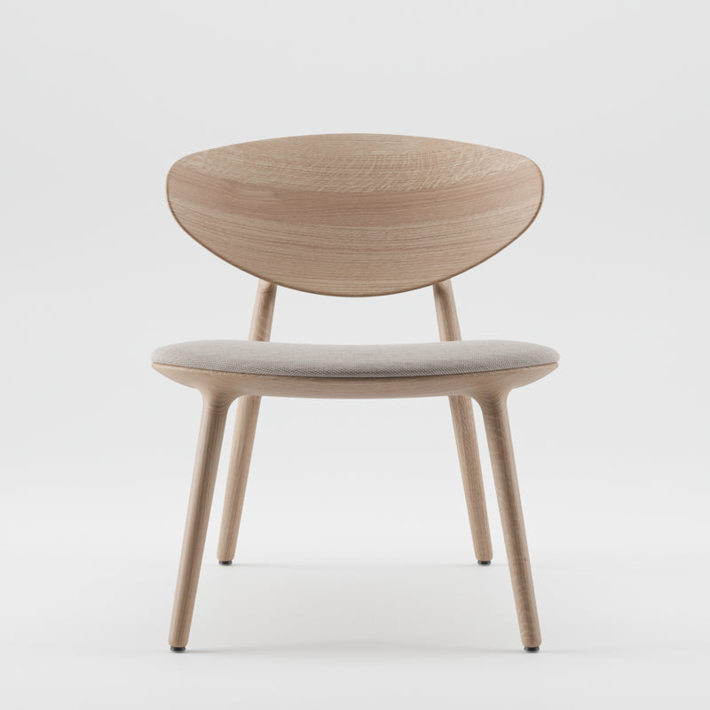 The Artisan WU Lounge Chair features solid wood construction with a light, natural finish, four legs, a curved backrest, and a light gray cushioned seat. Its sleek minimalist design exudes elegance against a plain white background.