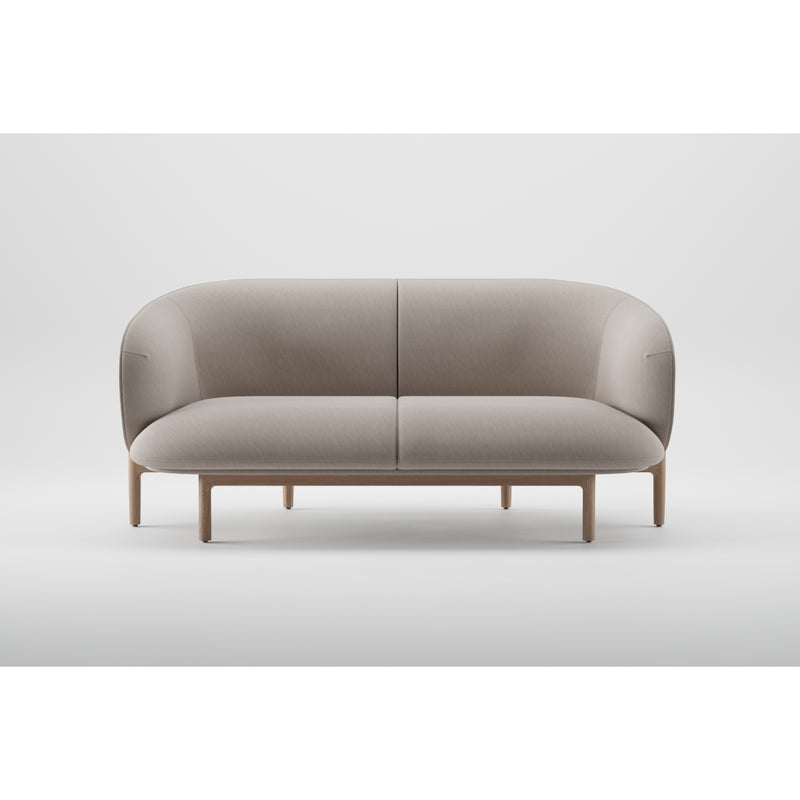 Part of Artisans MELA collection, the two-seater boasts a modern minimalist design with a curved backrest and wooden legs. Upholstered in light gray fabric, it creates a stunning contrast against a plain white background.