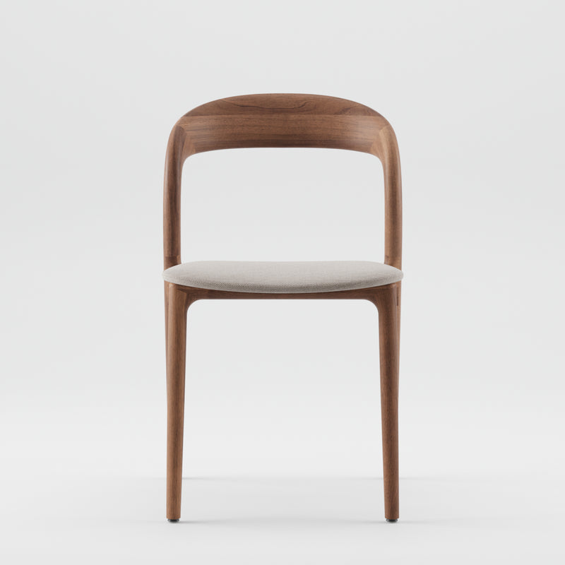 The NEVA light chair by Artisan showcases sleek minimalist lines with a modern curved backrest and light gray cushioned seat, crafted with artisanal techniques. It is set against a plain white background to highlight its design.