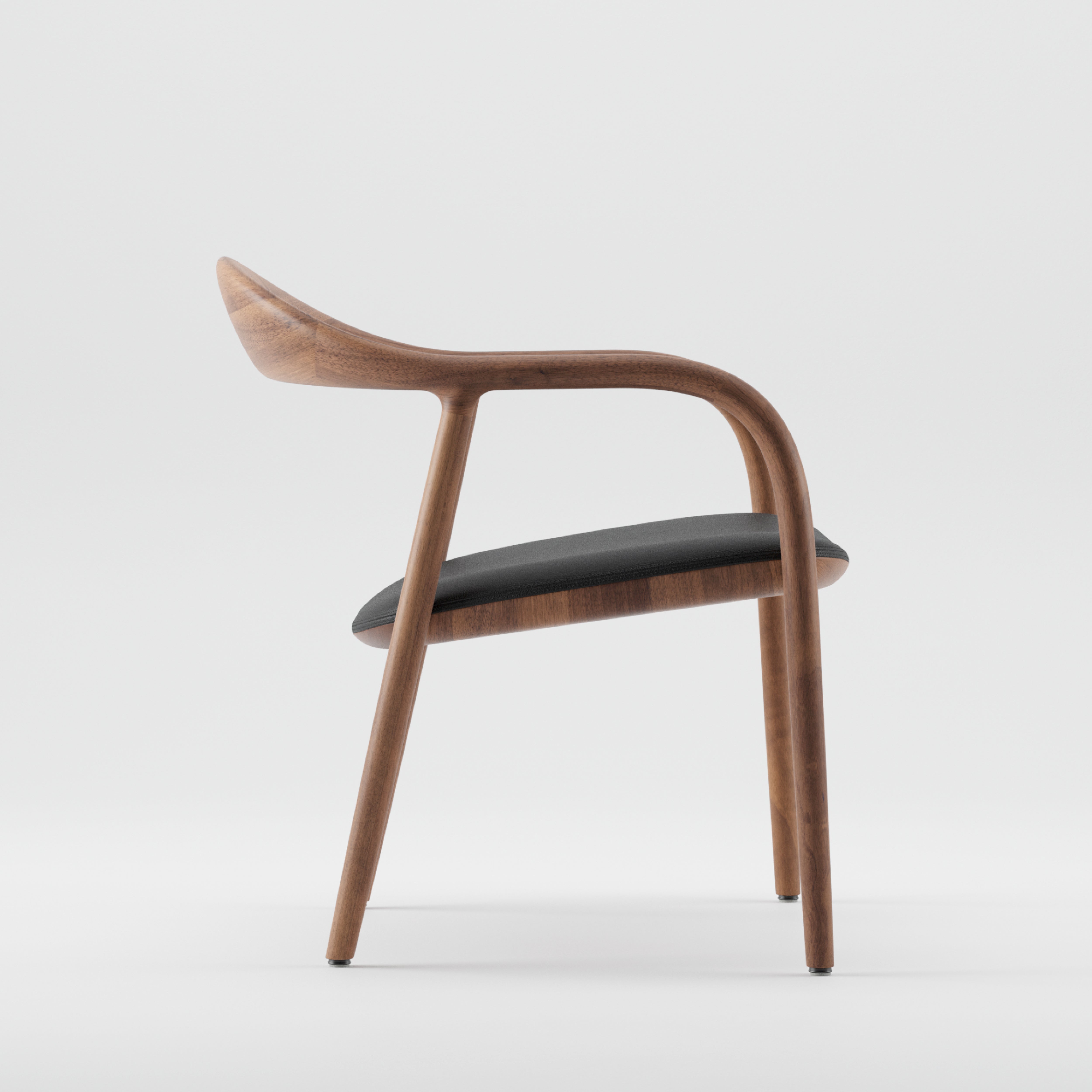 The Artisan NEVA Easy Chair boasts a modern, curved wooden frame made with 5-axis CNC technology. Its ergonomic design and comfortable cushioned black seat are elegantly displayed from the side against a white background.