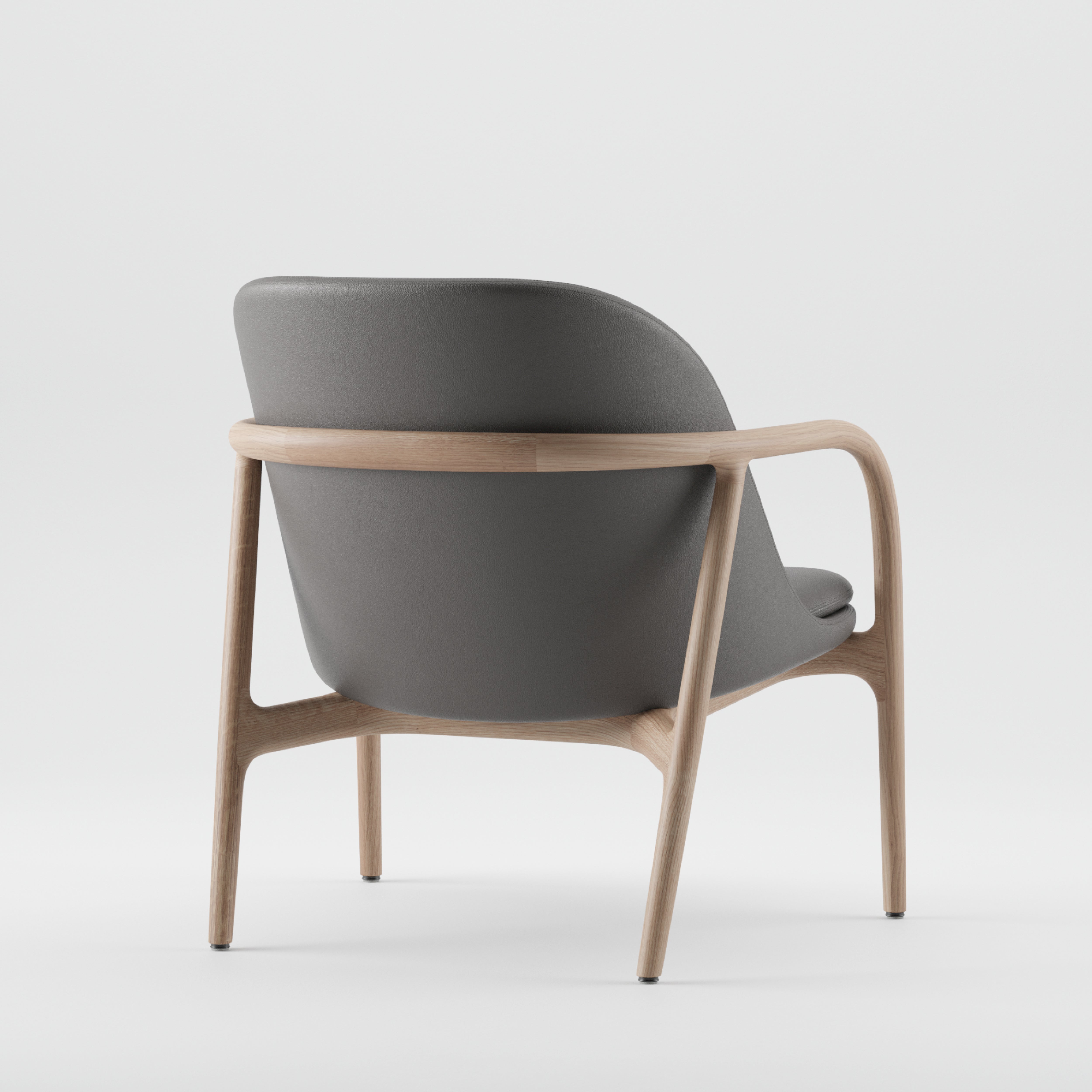 The NEVA Lounge Chair Trimmed by Artisan features a Scandinavian design with gray cushioned seat and backrest on a light wood frame. Photographed from the back on a white background, its sleek, curved design stands out.