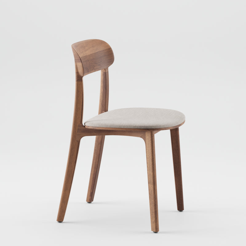 The TANKA Chair Upholstered by Artisan has a curved solid wood backrest, a light beige cushioned seat, and four slender legs, creating a simple and modern design against a white background.