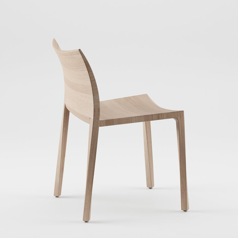 The TORSIO Chair by Artisan is a minimalist wooden chair crafted from solid wood, finished with natural oils, and featuring a curved backrest and four legs. Displayed on a plain white background, it showcases sleek modern lines while facing slightly to the left.