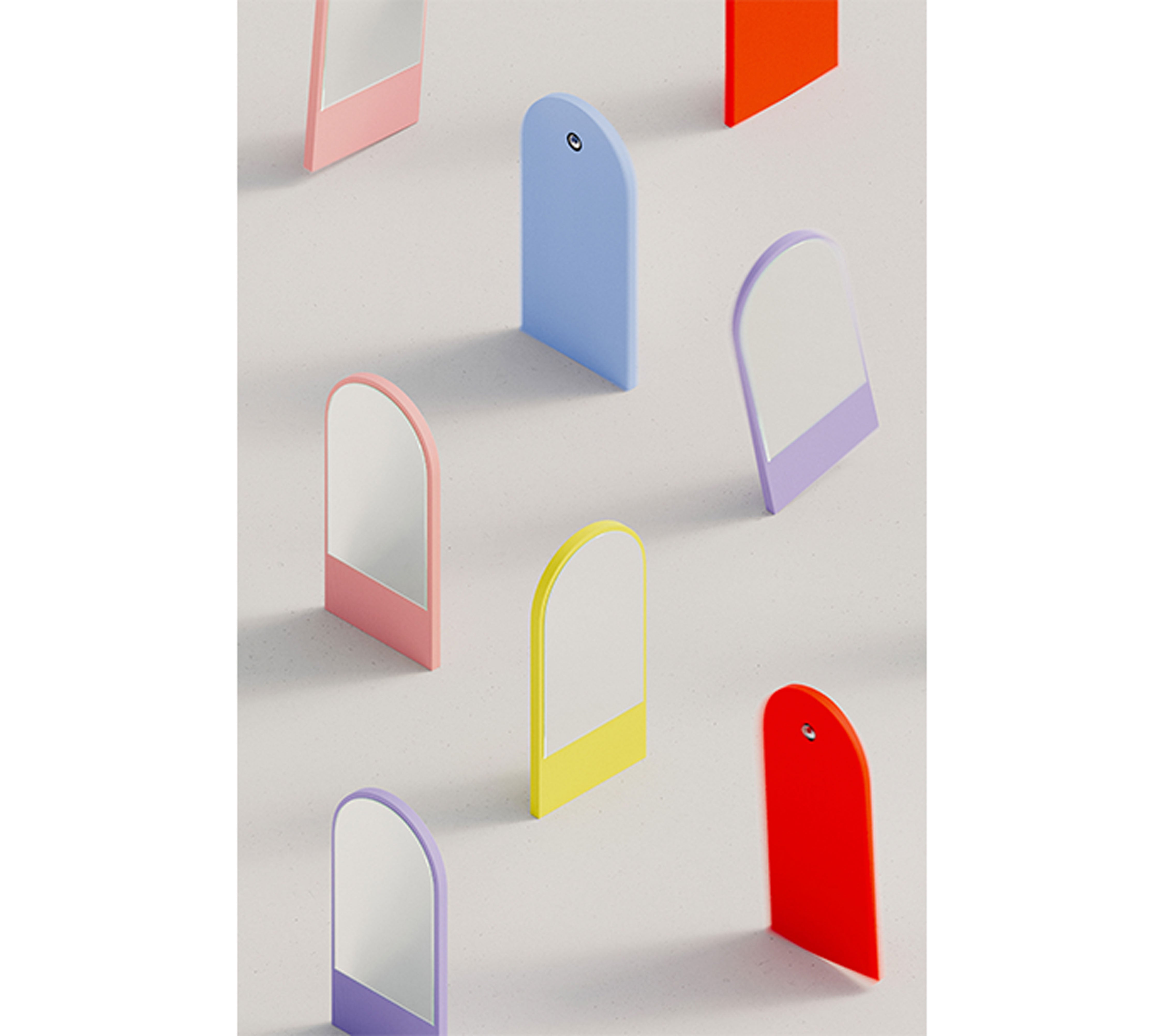 Abstract objects resembling mirrored panels stand on a light surface, showcasing colors like red, blue, yellow, and pink in geometric patterns with their shadows. These vibrant hues embody the bold aesthetic of the Friedrich Mini Mirror by Objekte unserer Tage.